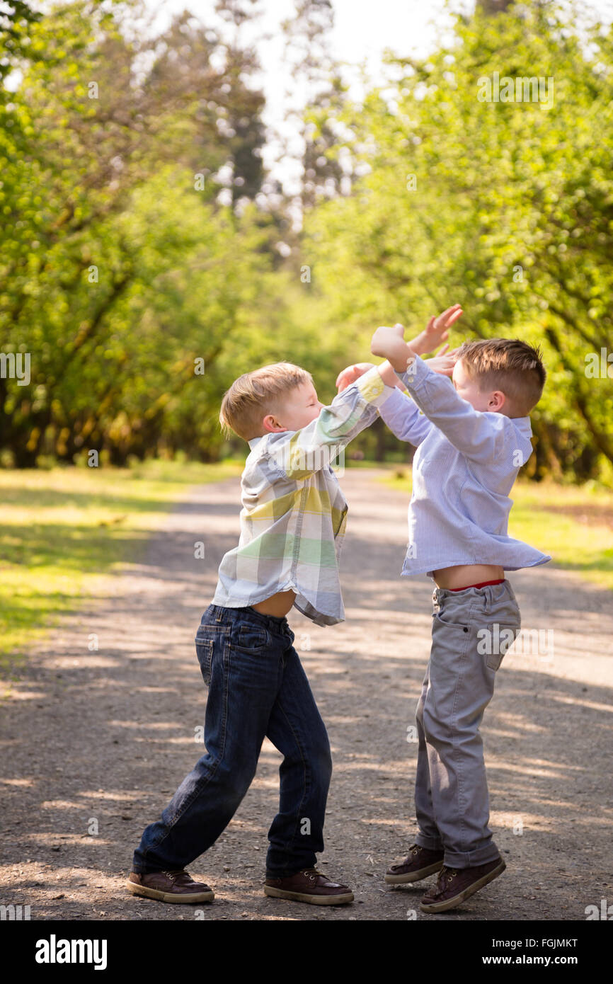 Two brothers together outdoors in a lifestyle portrait with natural