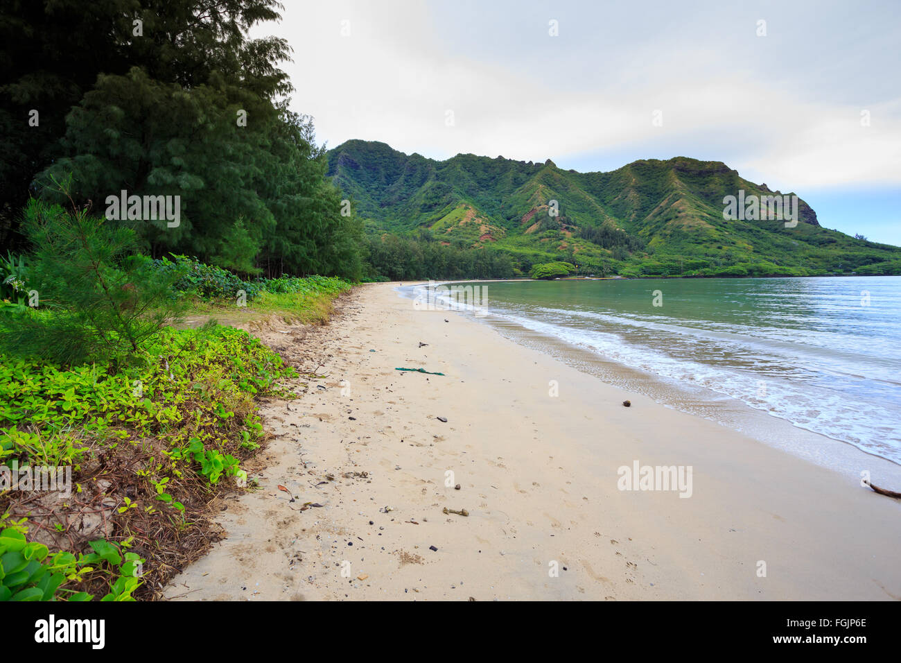 Kahana Bay as seen from the beach looking North with nobody there on a very slow day for tourism in Oahu Hawaii. Stock Photo