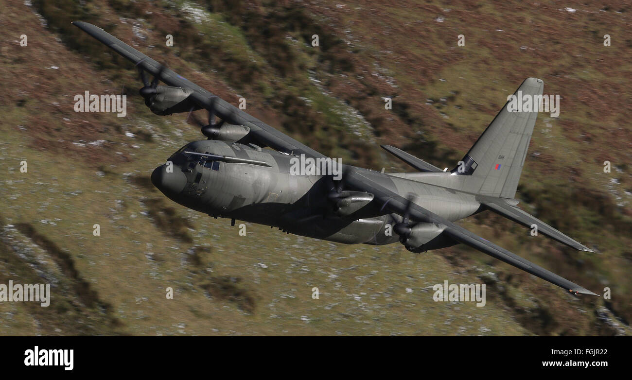 An RAF Lockheed C-130 Hercules approaches the Mach Loop, North Wales at low altitude Stock Photo