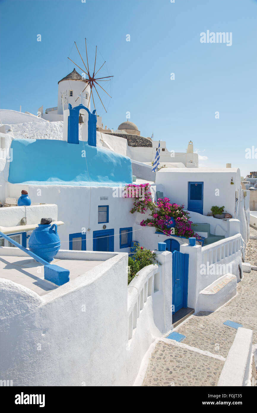 Santorini - The look to windmill and little typically white-blue chapel in Oia. Stock Photo