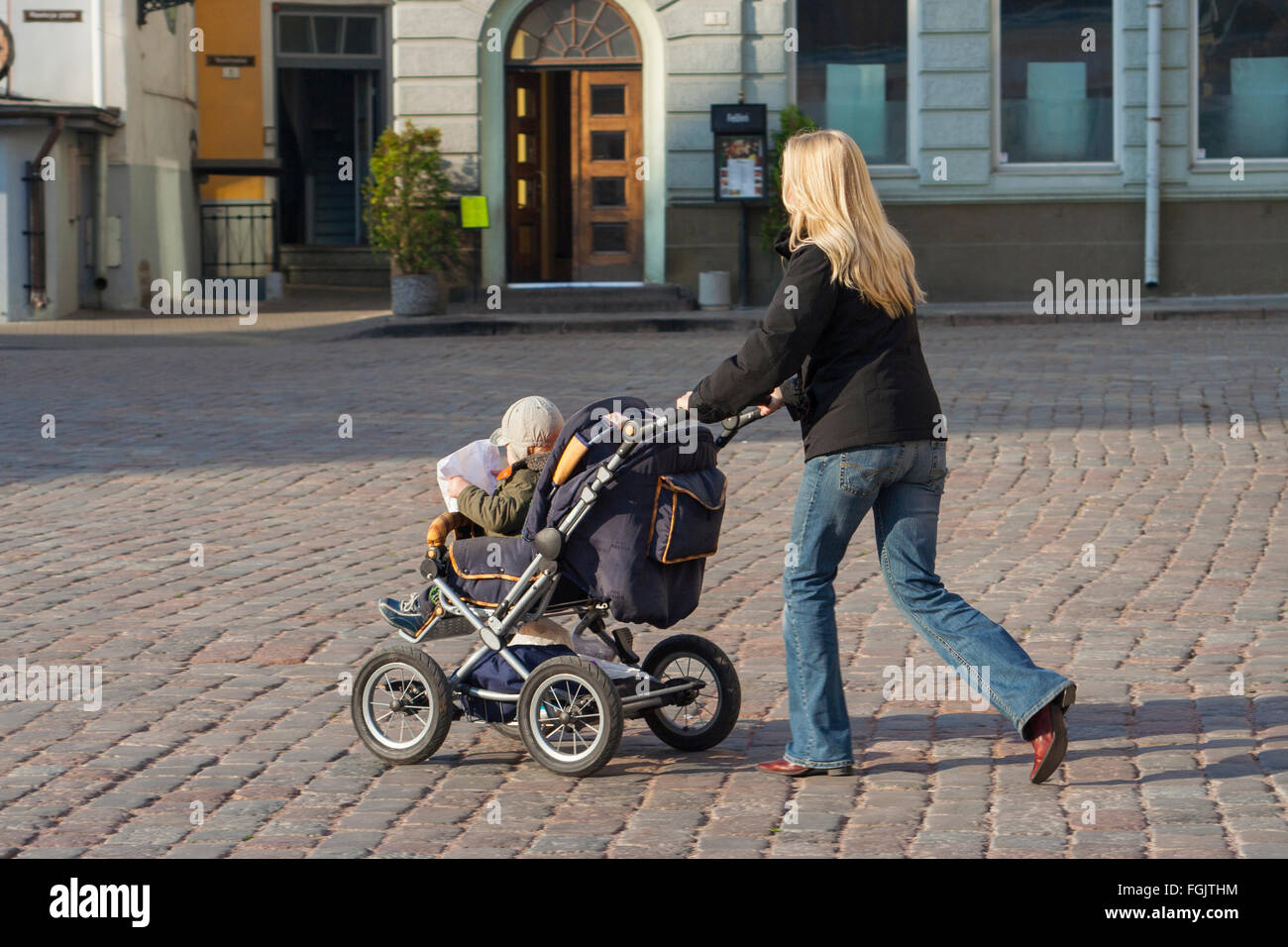 Mother pushing buggy Raekoja plats, Tallinn, Estonia Stock Photo