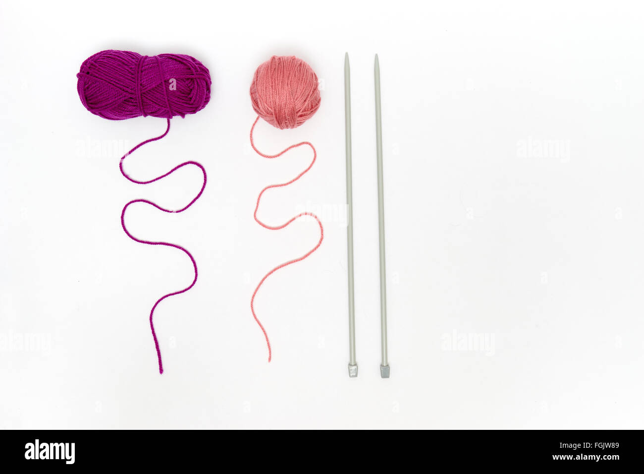 Balls of yarn with knitting needles isolated on white Stock Photo - Alamy