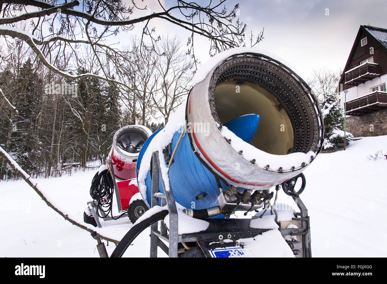 Snow making machine on piste at ski resort in snowy country Stock Photo
