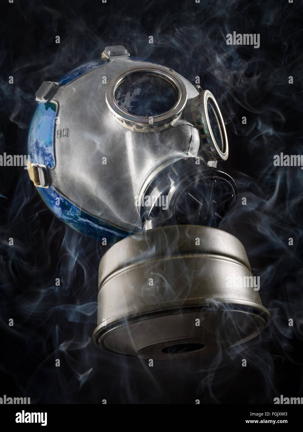 Planet Earth with gas mask as a metaphor of global air pollution Stock Photo