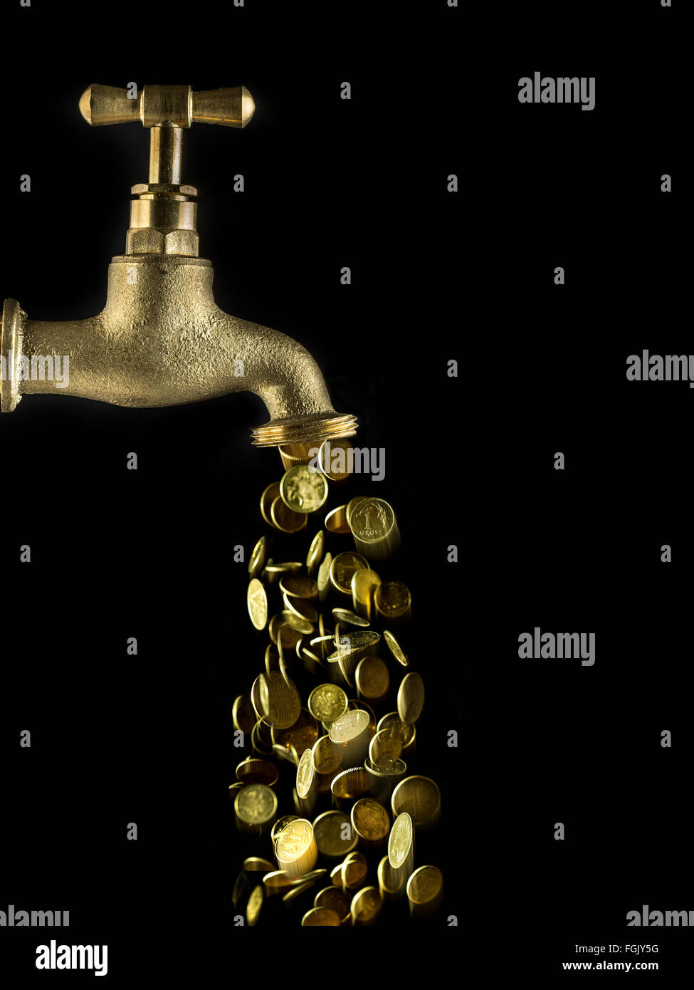 Small change flowing down from golden tab on black background Stock Photo