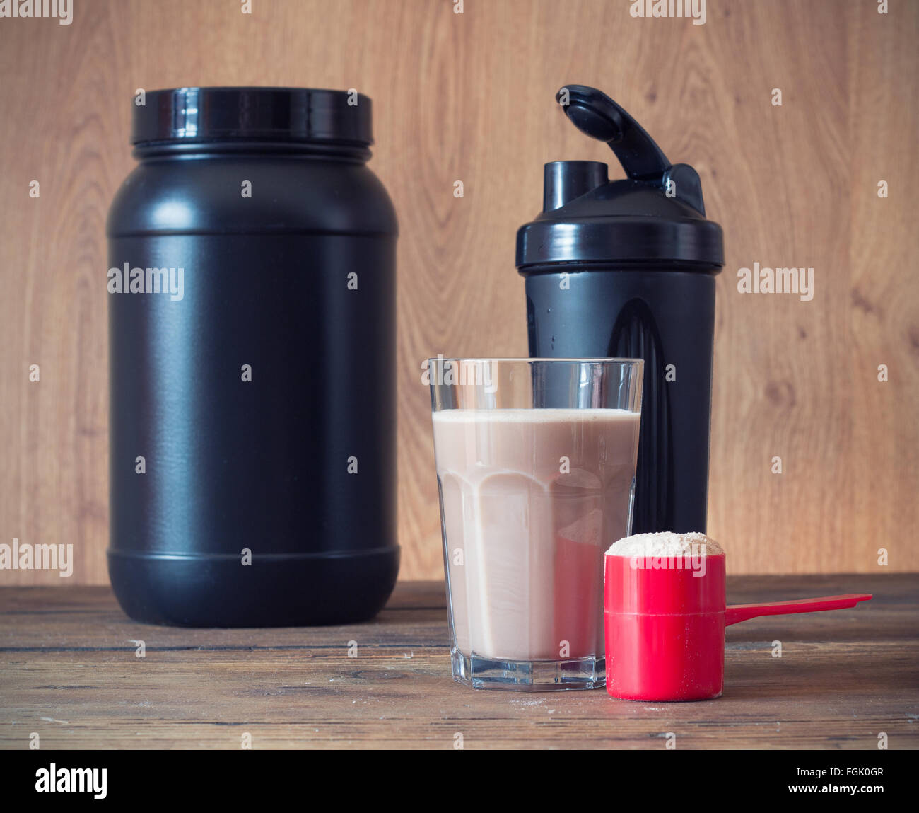 Whey Protein Powder In Scoop With Vitamins And Plastic Shaker On Wooden Background Stock Photo