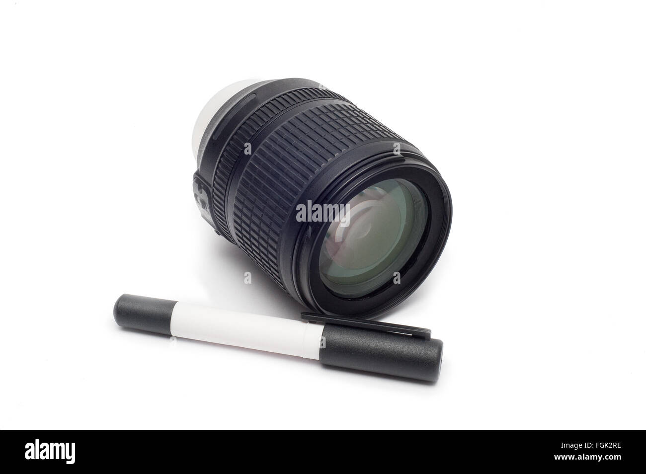 Cleaning the lens. Camera lens with lens brush while isolated on white