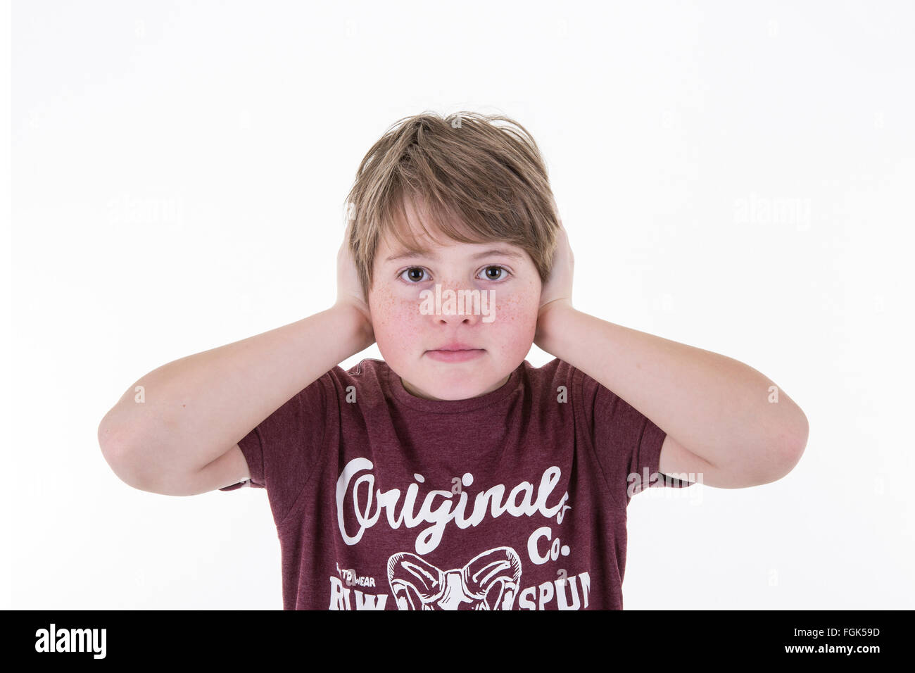 Young Boy covers his ears on a white background Stock Photo Alamy