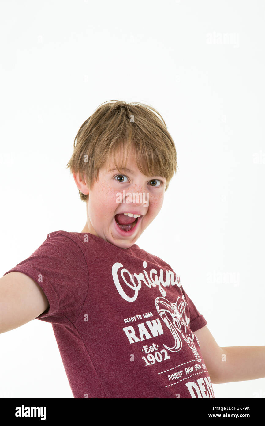 Young Boy Smiles and Waves Against White Background Stock Photo