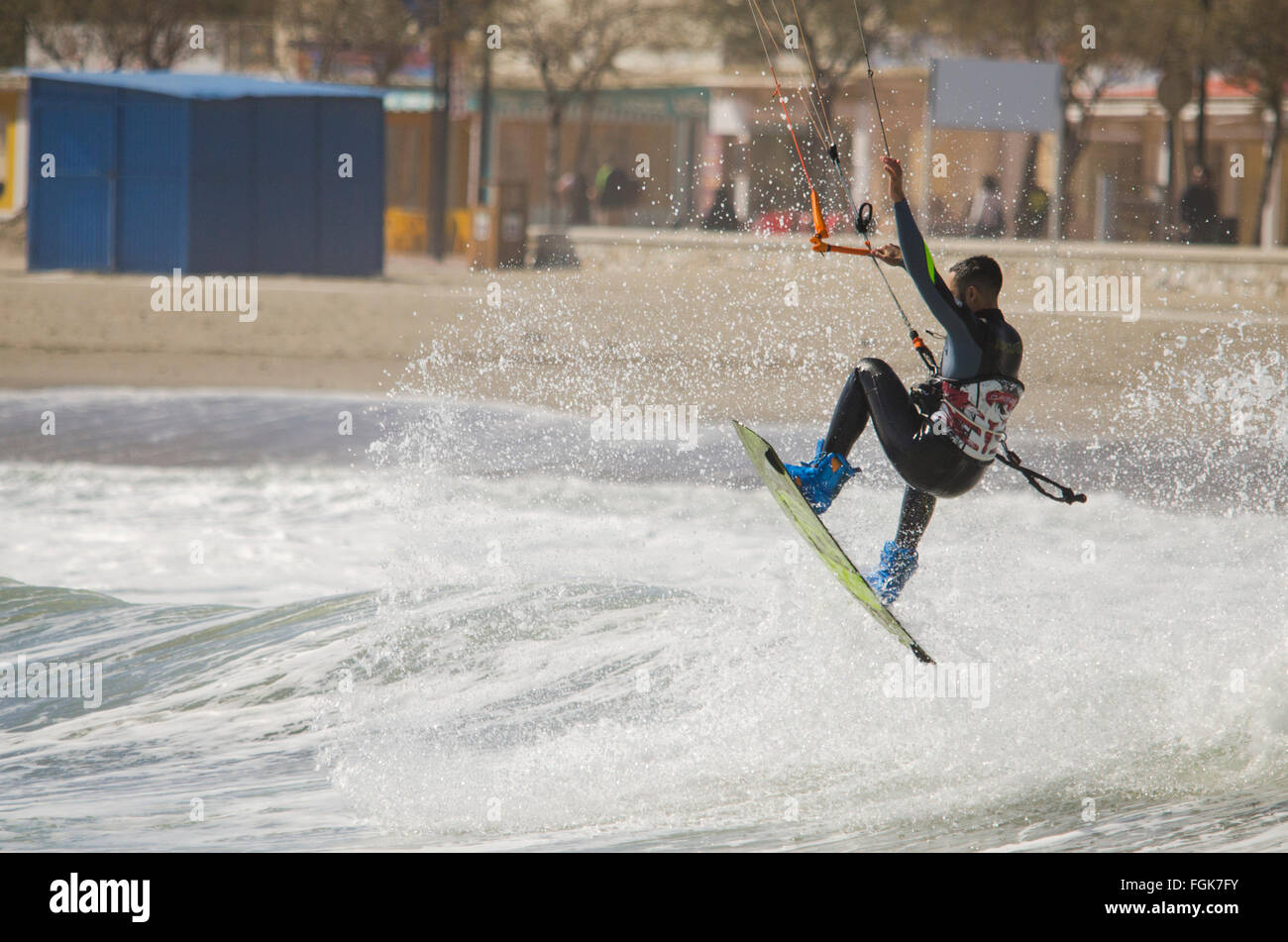 Fuengirola, Malaga, Andalusia, Spain. 20th February, 2016. Kitesurfer takes advantange of orange code alarming high waves. Credit:  Perry van Munster/ Alamy Live News Stock Photo