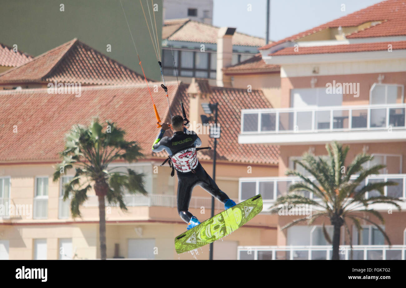 Fuengirola, Malaga, Andalusia, Spain. 20th February, 2016. Kitesurfer takes advantange of orange code alarming high waves. Credit:  Perry van Munster/ Alamy Live News Stock Photo