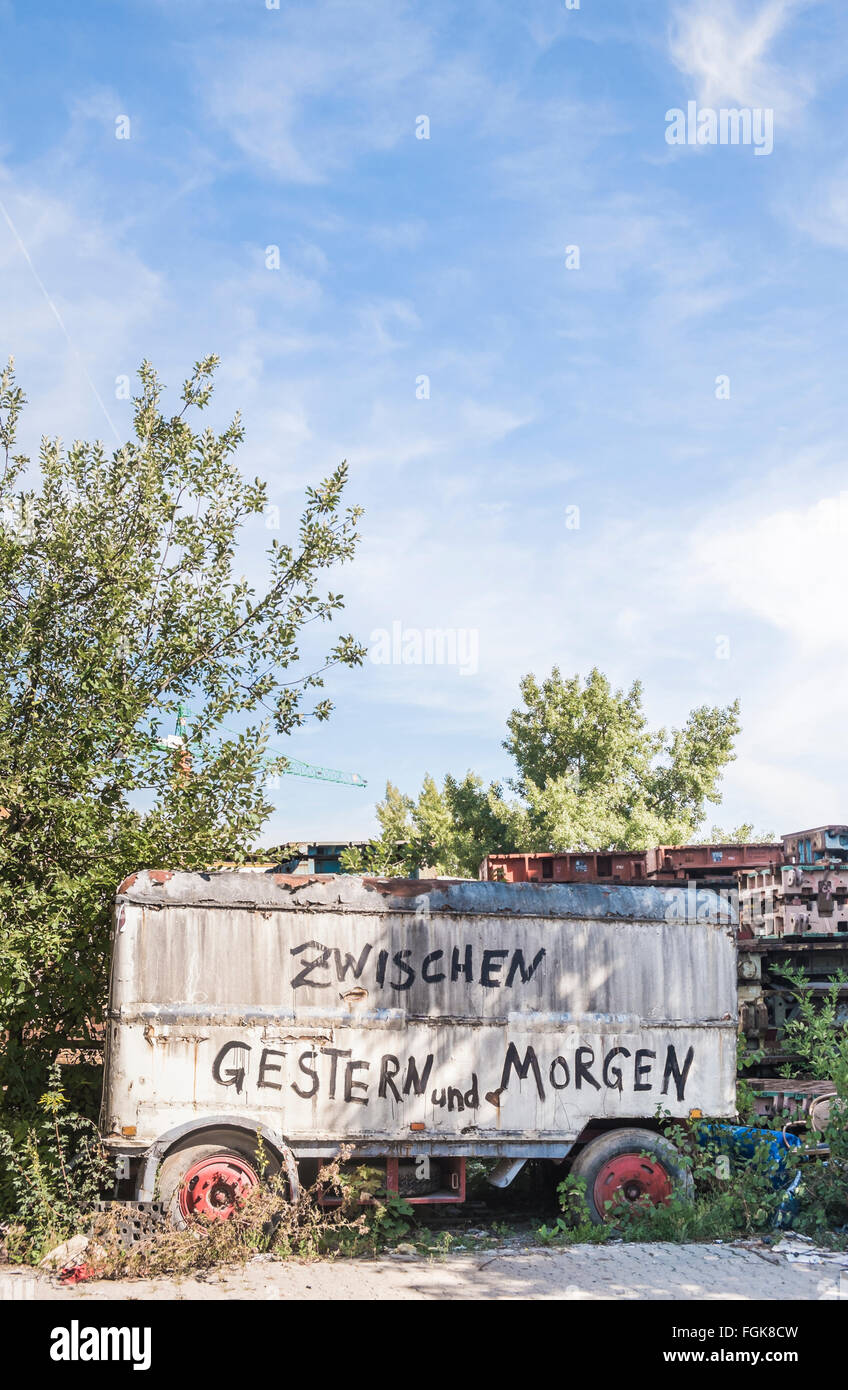 old construction trailer bearing the inscription  zwischen gestern und morgen ,   between yesterday and tomorrow  Stock Photo