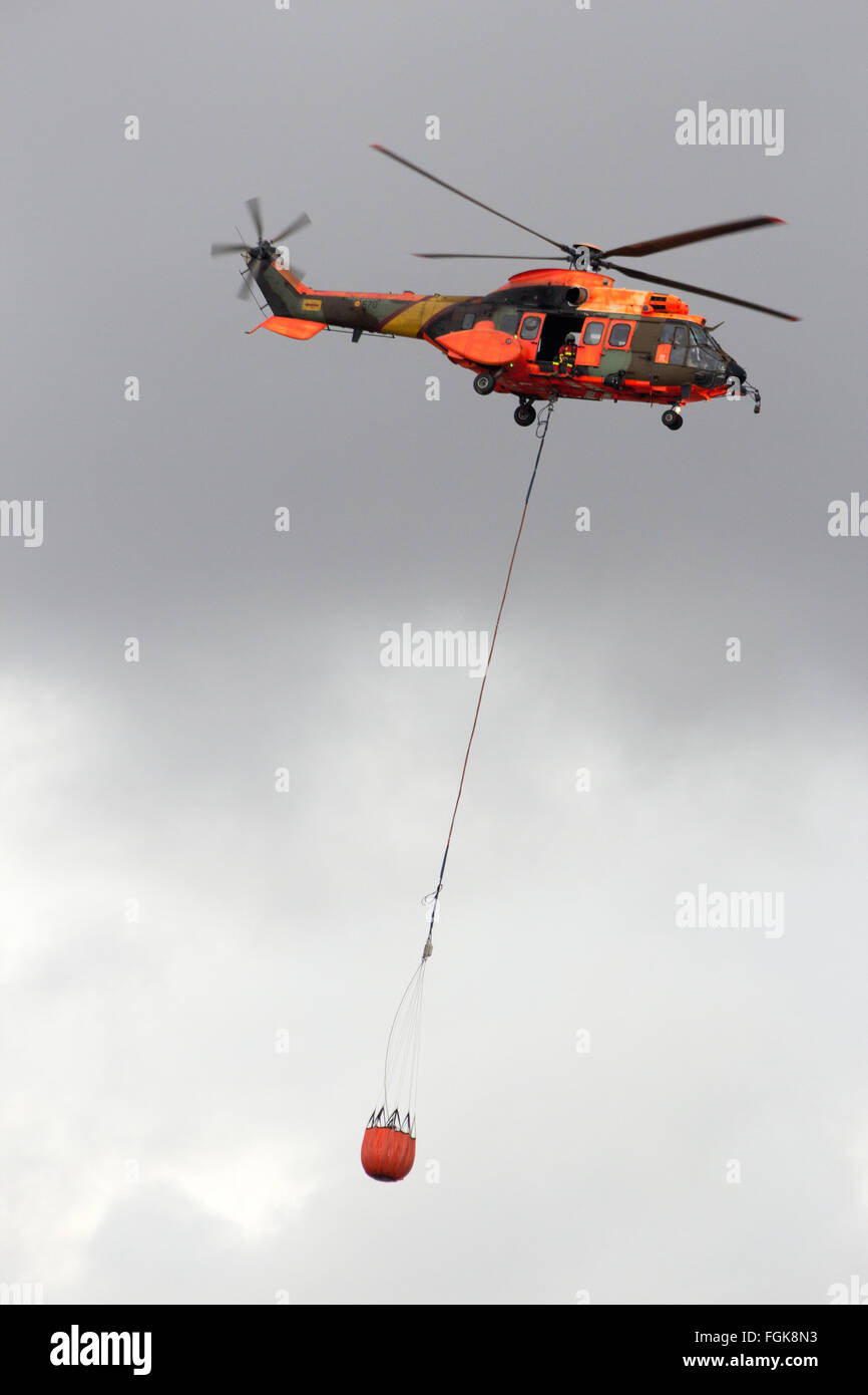 Spanish Air Force Eurocopter Cougar helicopter with a water bucket for firefighting Stock Photo