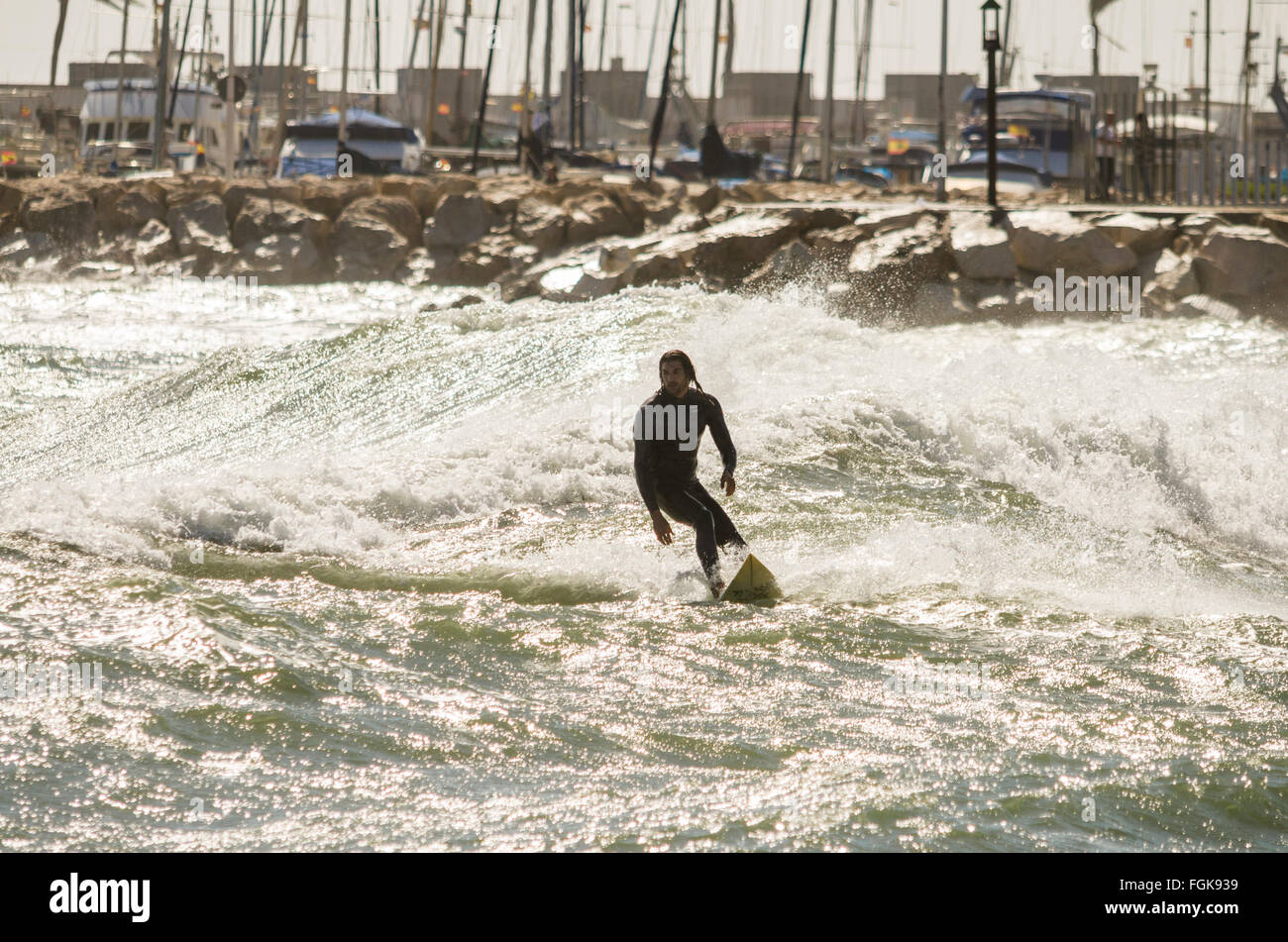 Fuengirola, Malaga, Andalusia, Spain. 20th February, 2016. Code orange is given for high waves and wind. Surfer takes advantage of high waves. Credit:  Perry van Munster/ Alamy Live News Stock Photo