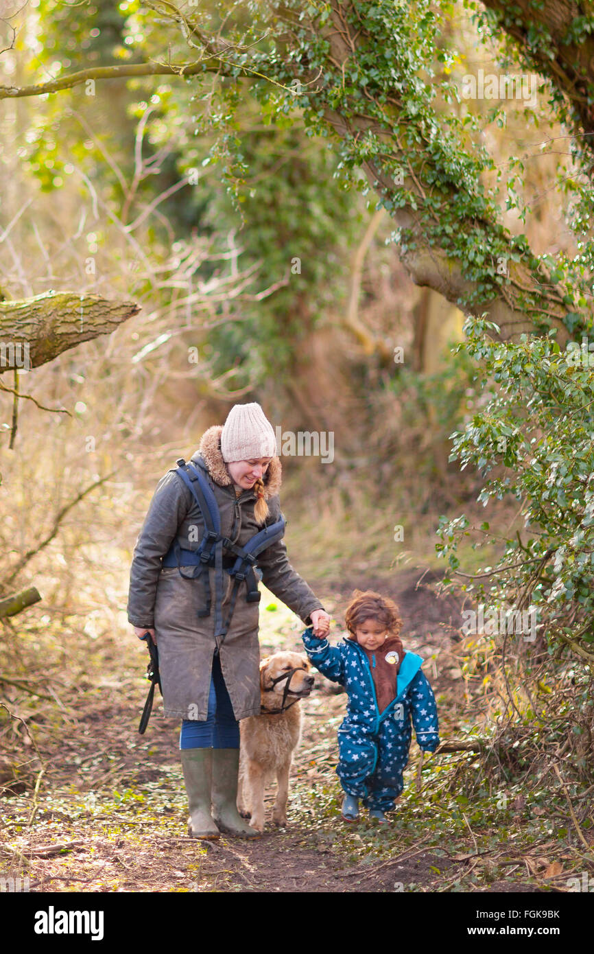 A March woodland walk for mother and three year old boy. Stock Photo