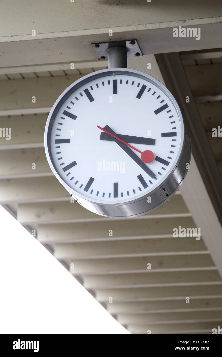 A train station clock hanging on the roof Stock Photo Alamy