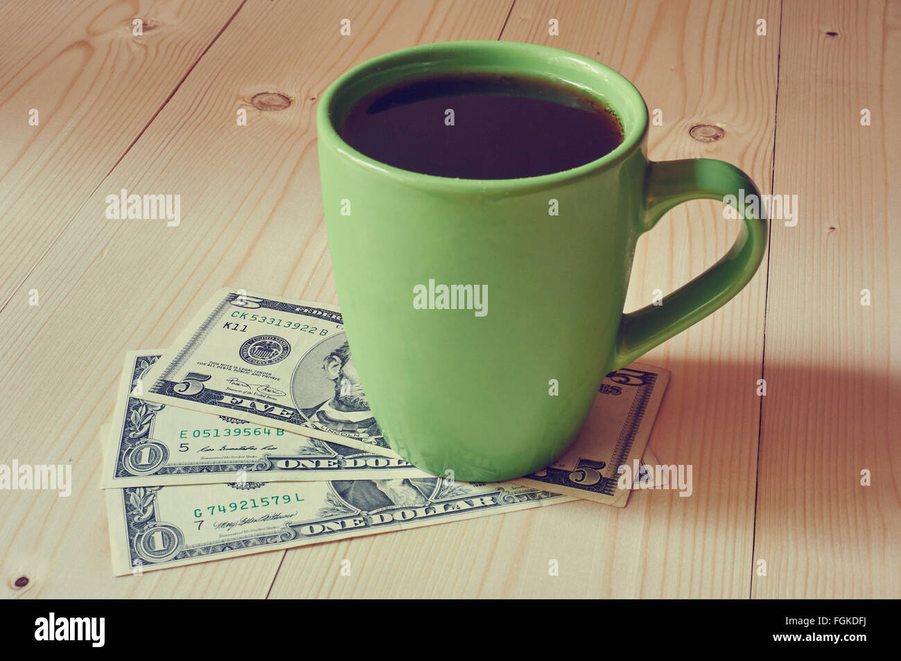 Cup of coffee on dollar bills pile. Toned image. Place for text Stock Photo  - Alamy
