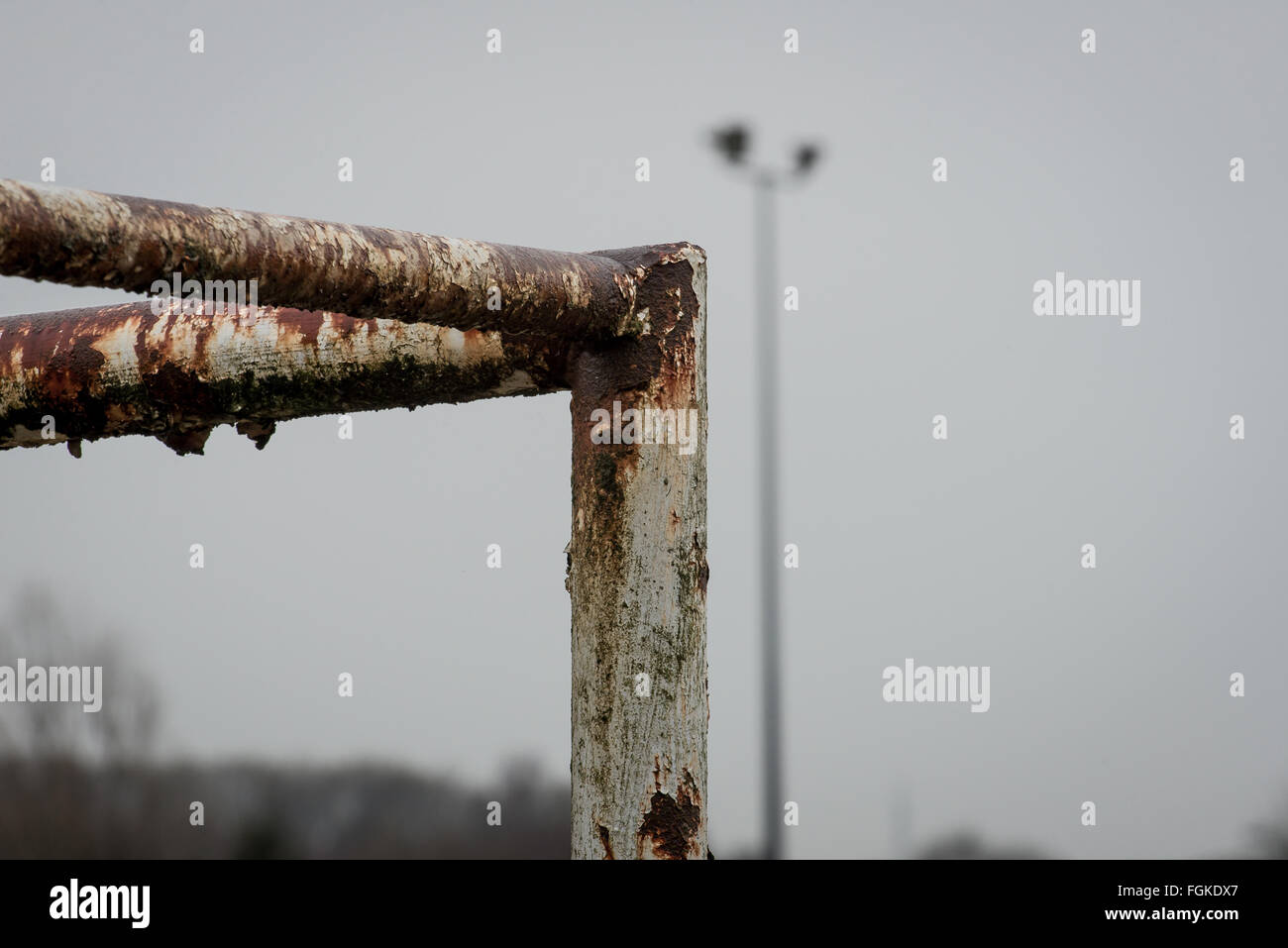 Deteriorated goalposts with out of focus floodlight Stock Photo