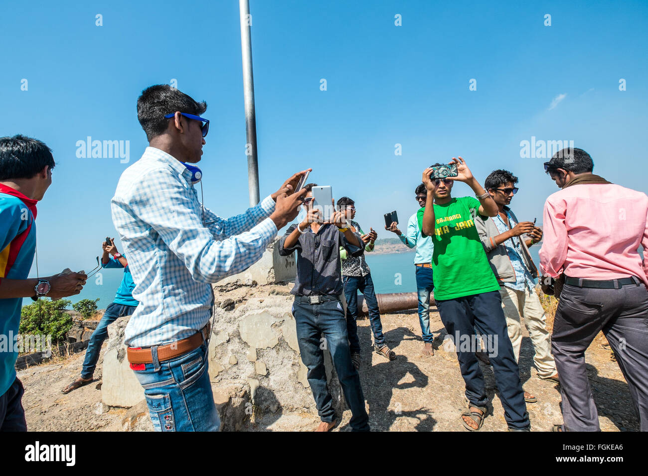 Young Indians taking pictures with their mobile phones Stock Photo
