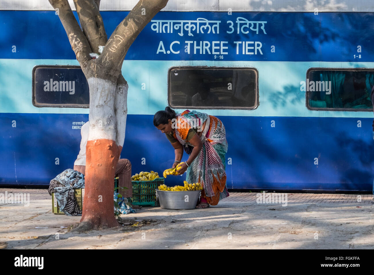Vendor selling snacks to passengers on an Indian railways train Stock Photo