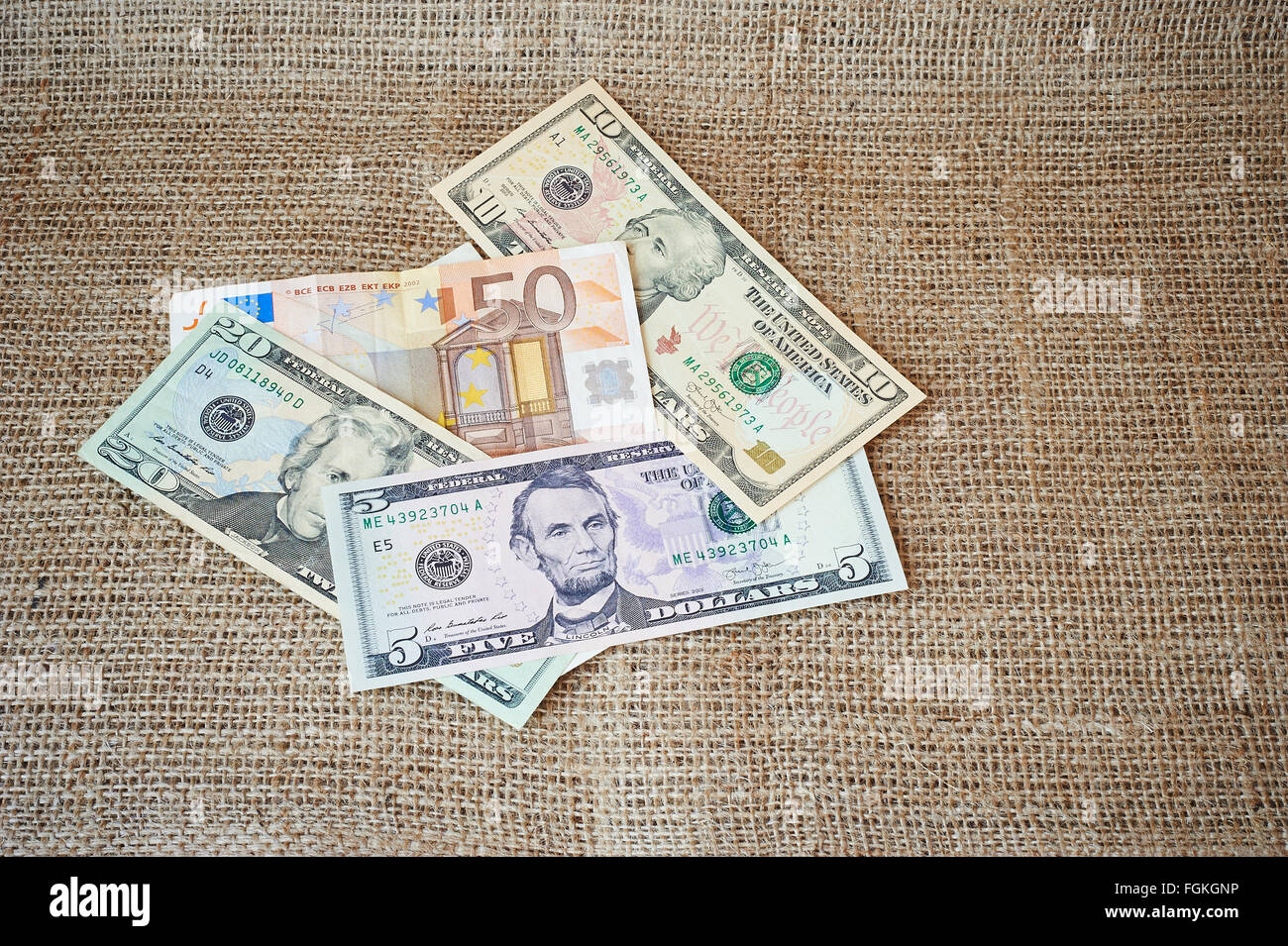 Dollars and euro on a burlap background with place for text Stock Photo