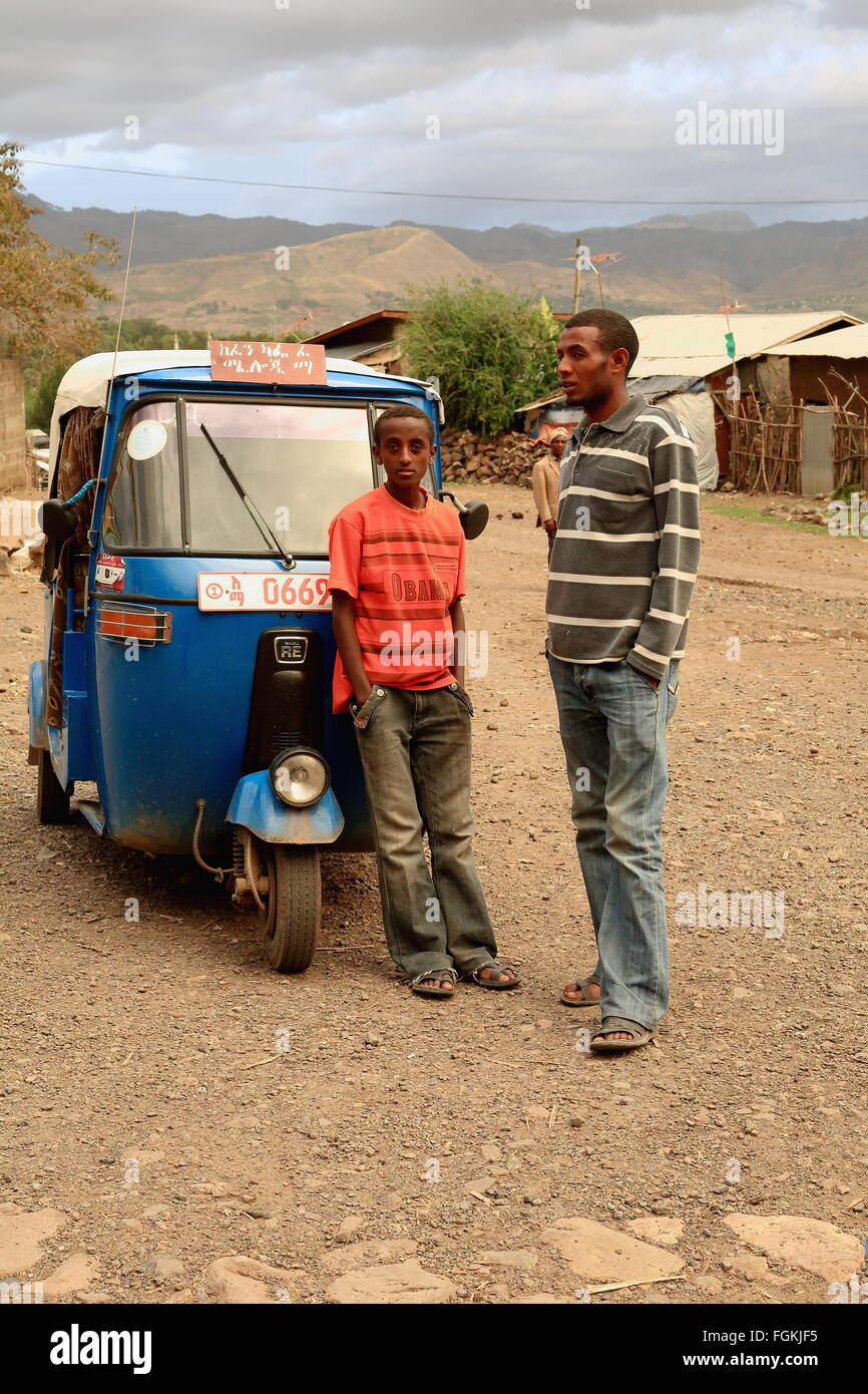KOMBOLCHA,ETHIOPIA-MARCH 24:Man and boy wait beside an autorick outside Bete Gebriel-St.Gabriel church for the religious service Stock Photo