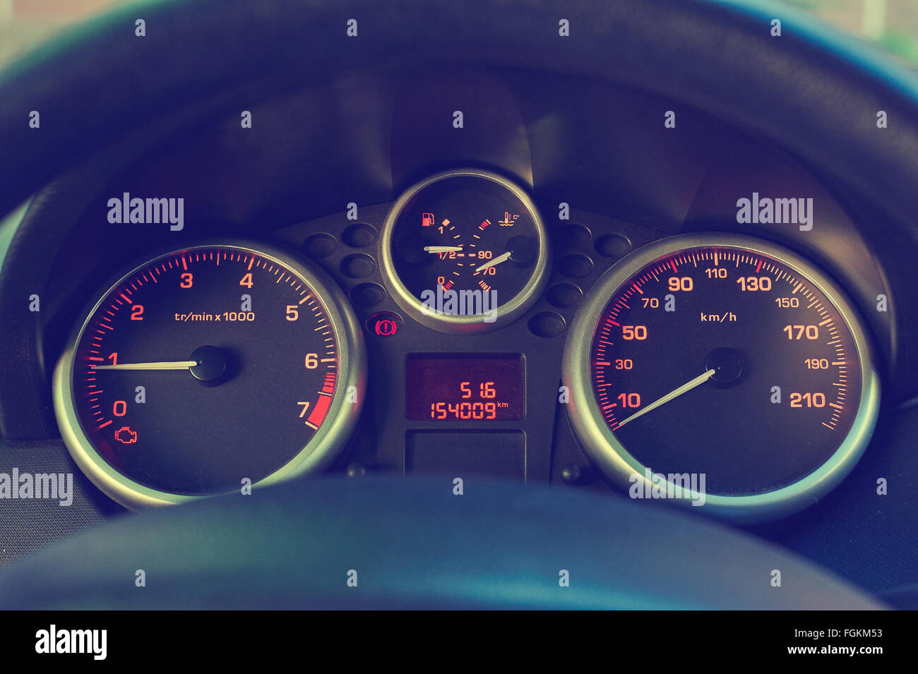 Backlit gauges of an automobile. Orange glowing meters with a red ...