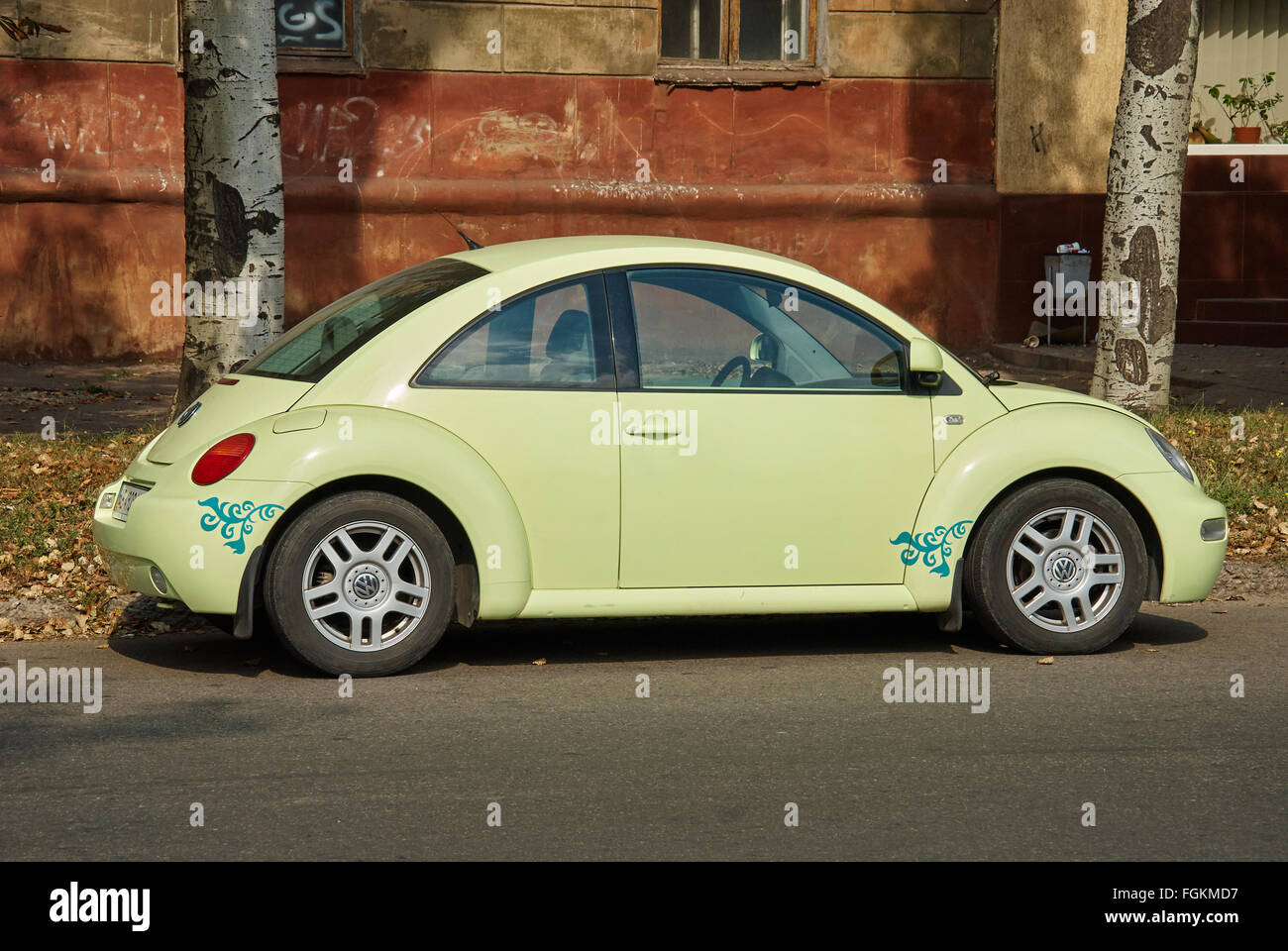Krivoy Rog, Ukraine - September 24, 2015: Light green Volkswagen New Beetle car parked in a street of the city centre. Stock Photo