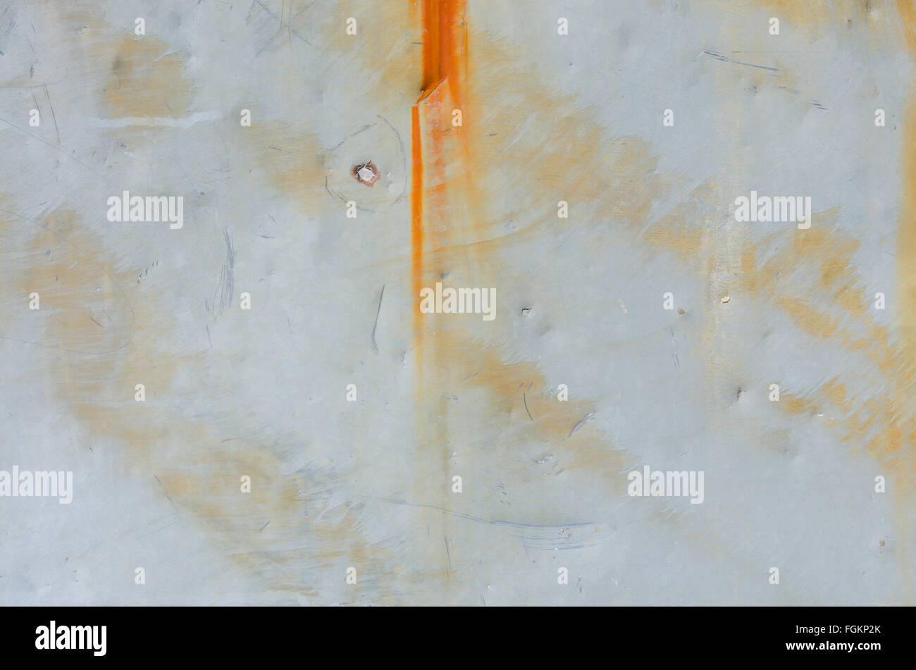 Rusty streaks and bullet hole on sheet metal background image Stock Photo