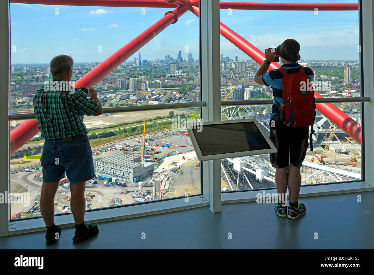 London skyline distant beyond East London urban landscape seen by visitors to Arcelor Mittal Orbit observation tower Queen Elizabeth Olympic Park UK Stock Photo