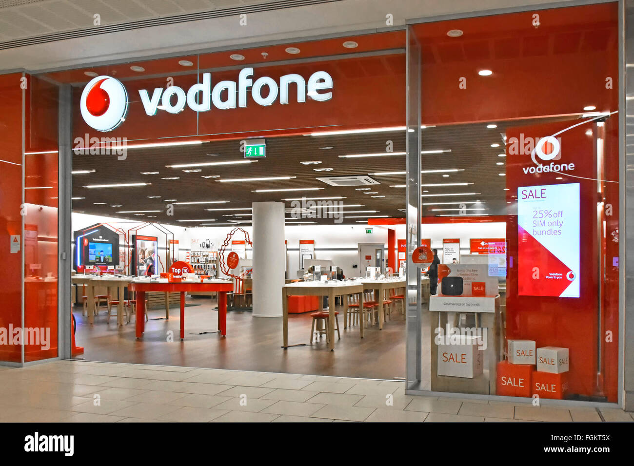 Vodafone red shop frontage logo & brand sign with interior view of