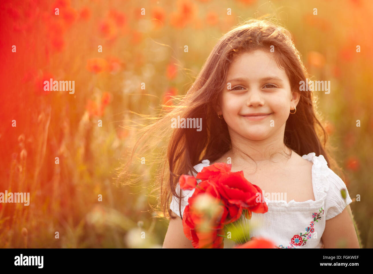 Happy girl with poppies. Stock Photo