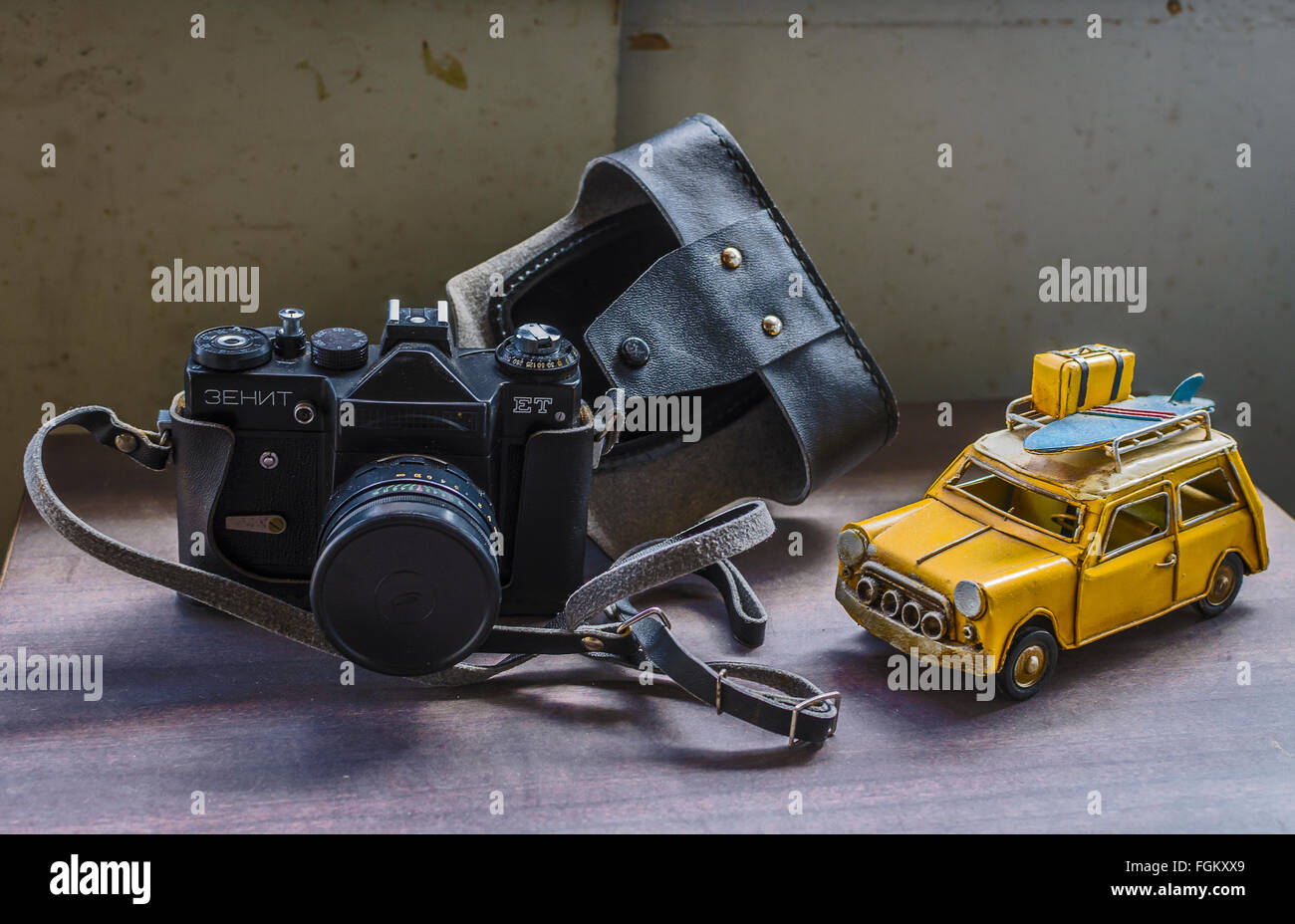 View of an old camera and a yellow toy car Stock Photo