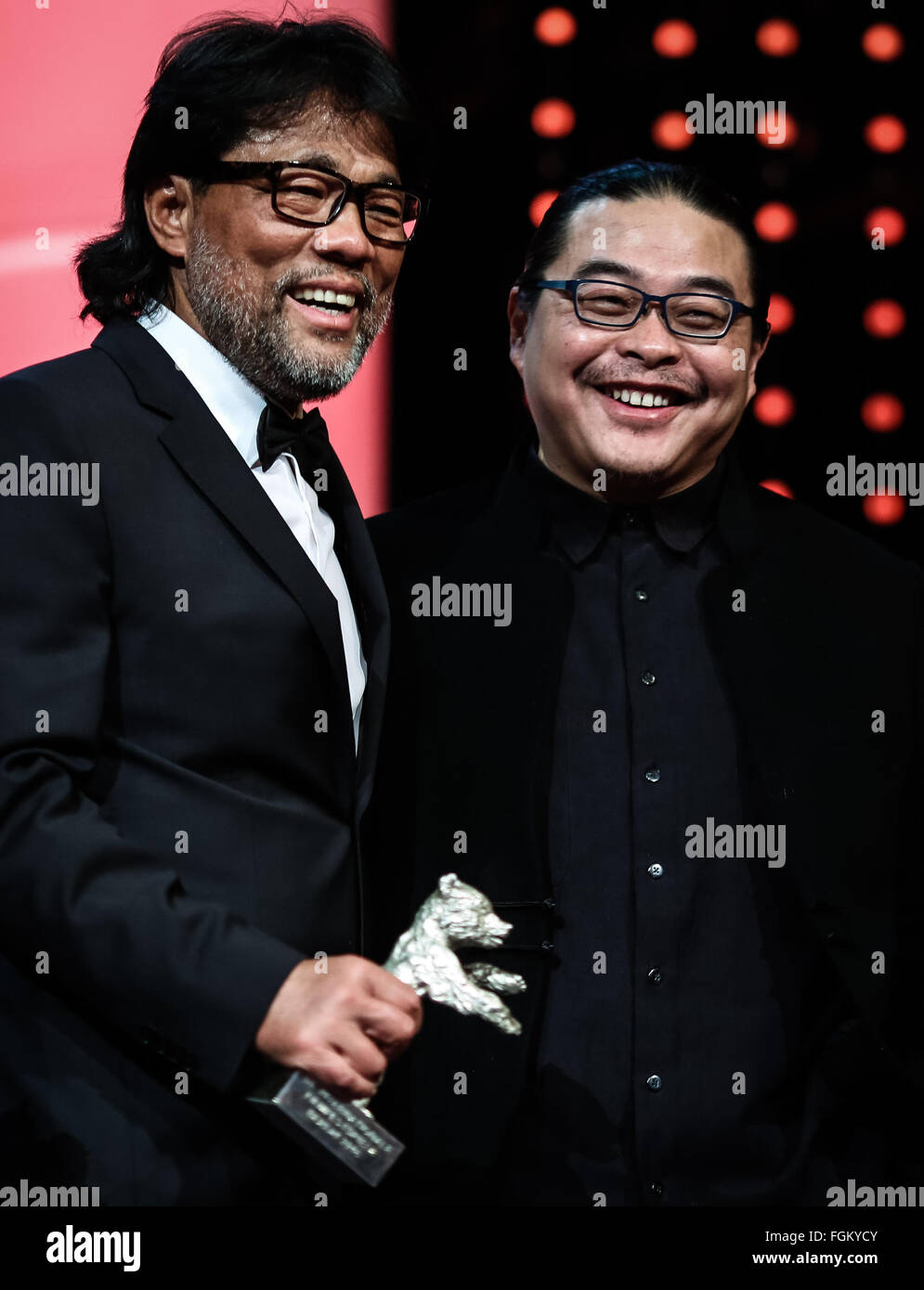 Berlin, Germany. 20th Feb, 2016. Mark Lee Ping-Bing (L), Cinematographer of the movie 'Crosscurrent' (Chang Jiang Tu), holds the Silver Bear for Outstanding Artistic Contribution standing with the movie's director Yang Chao during the awards ceremony of the 66th Berlinale International Film Festival in Berlin, Germany, Feb. 20, 2016. © Zhang Fan/Xinhua/Alamy Live News Stock Photo
