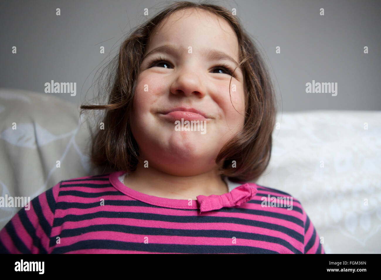 Disgusted three years old  little girl. Indoors portrait Stock Photo