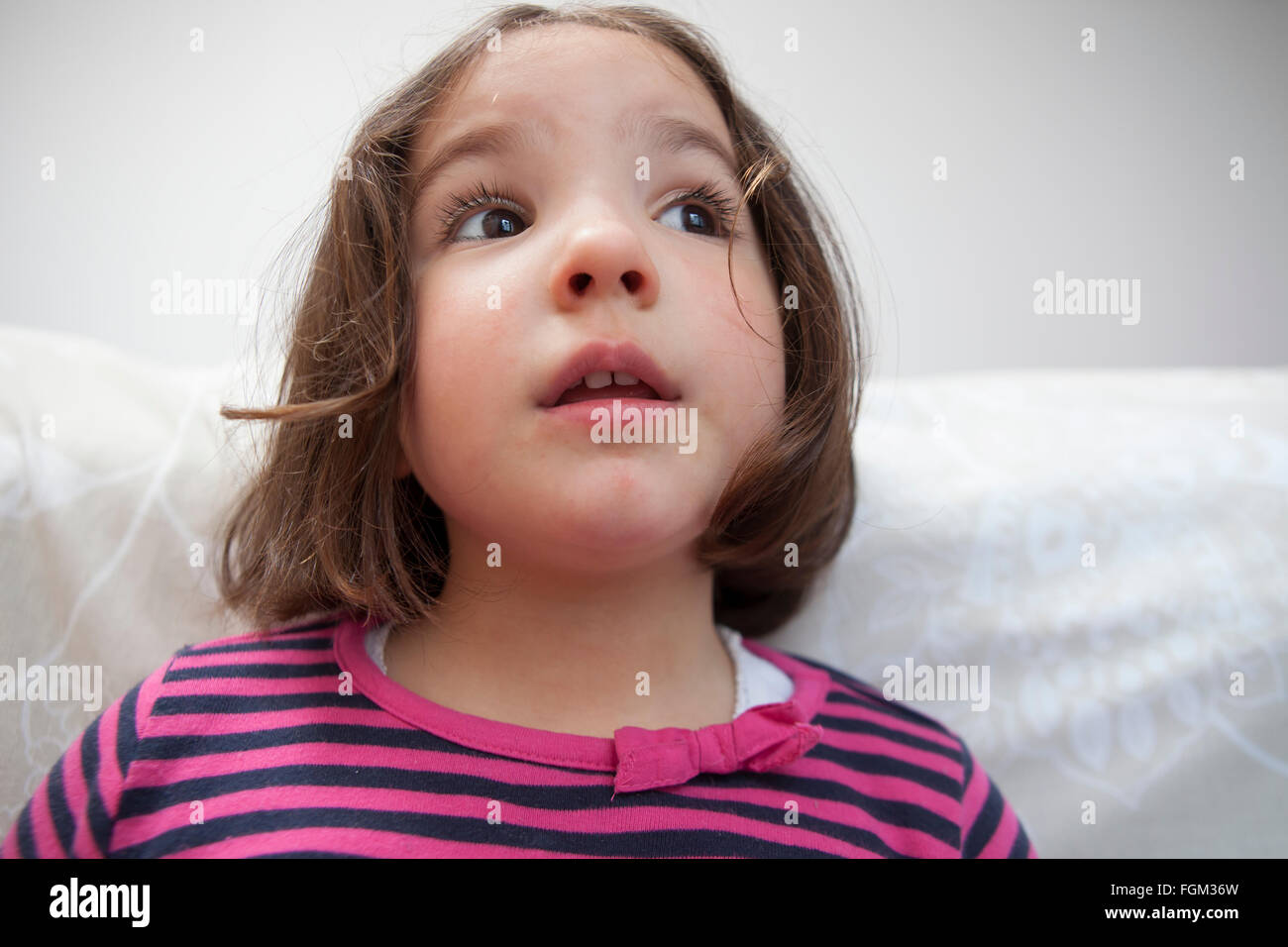 Distracted three years old  little girl. Indoors portrait Stock Photo