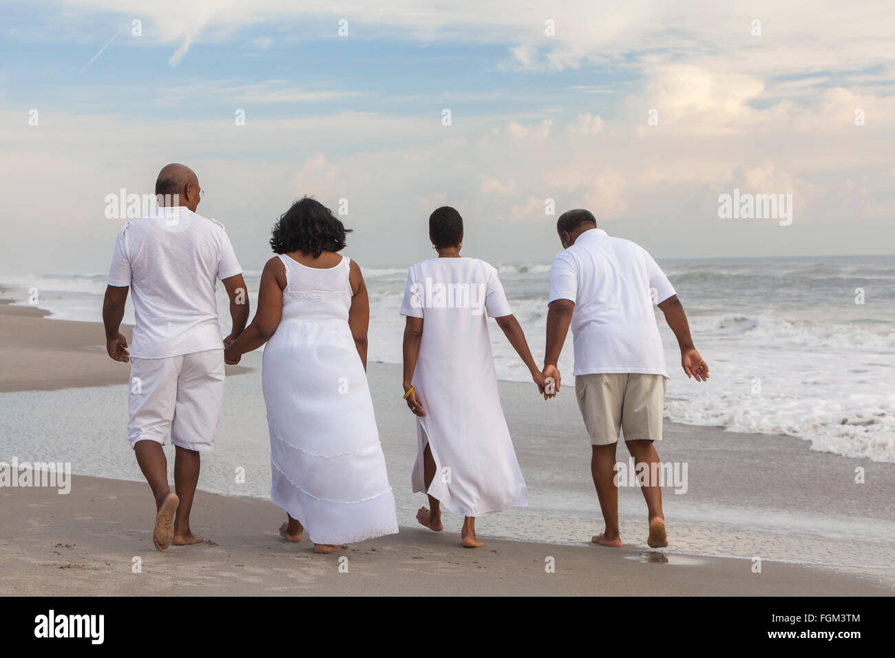 Happy romantic senior African American men and women couples walking ...