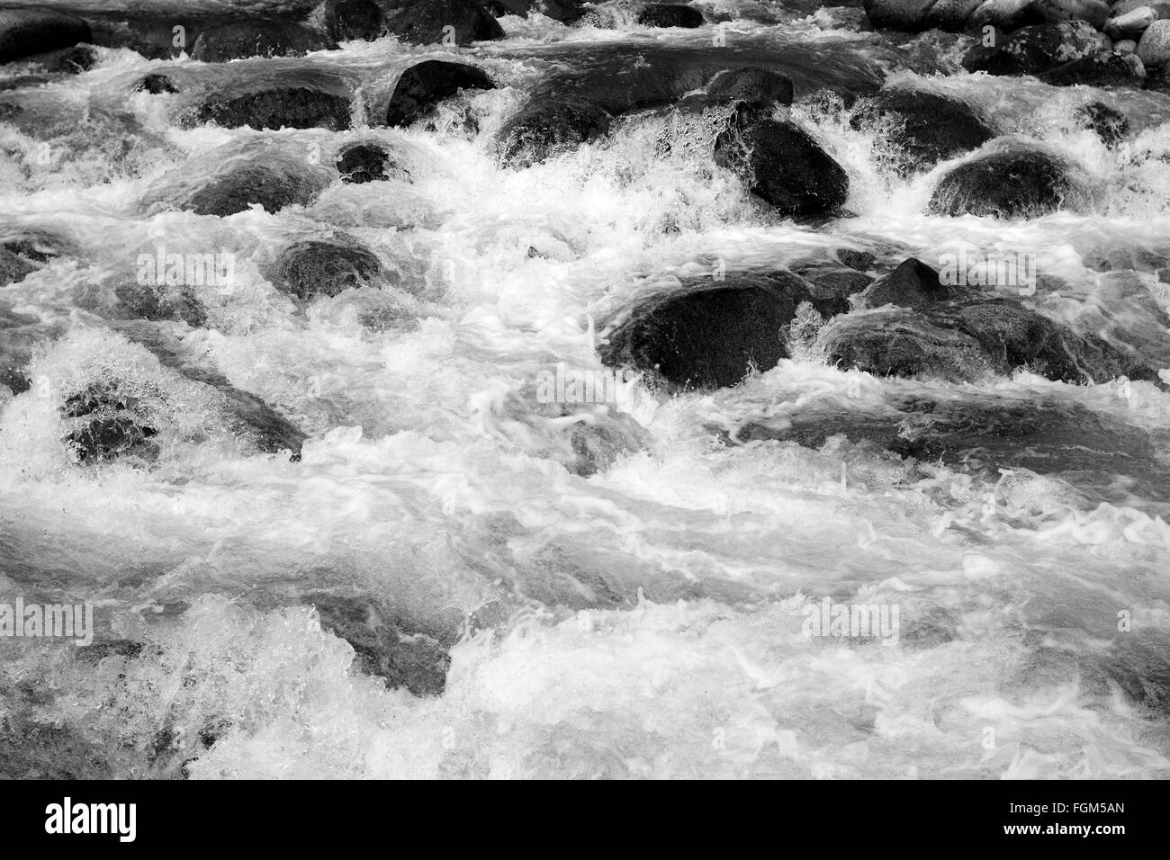 The rushing water of the river flowing down from the high mountains of Hatcher Pass in Alaska Stock Photo