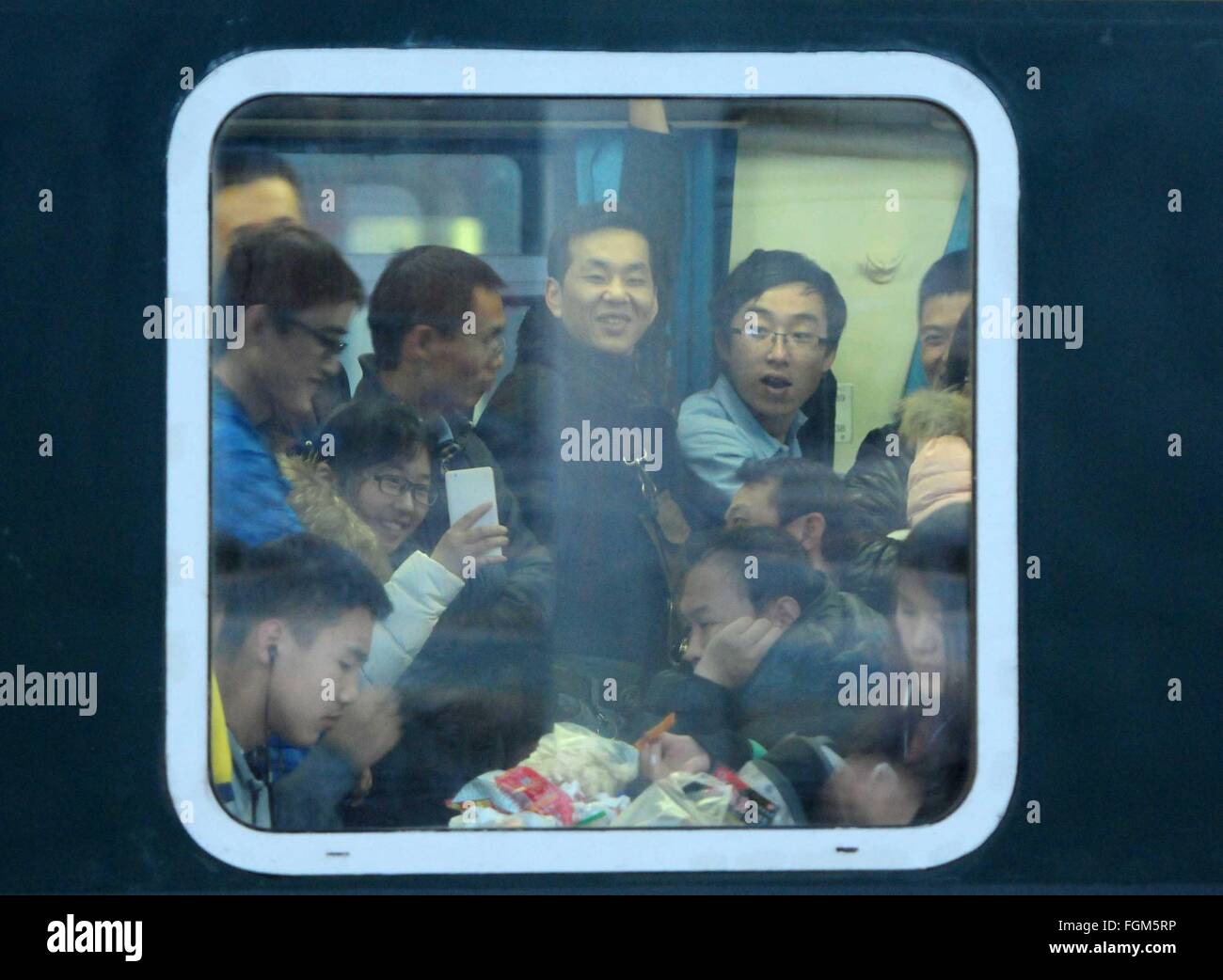 Beijing, China's Jiangxi Province. 13th Feb, 2016. Passengers are seen in a train at the railway station in Jiujiang, east China's Jiangxi Province, Feb. 13, 2016. Chinese passengers made a record number of trips during the Spring Festival holiday, according to the Ministry of Transport (MOT) on Sunday. Passenger trips reached 400 million from Feb. 7 to 13, up 6.7 percent from last year, MOT data showed. Over 47 million trips were made by rail, more than 333 million on road and about 8.5 million by air. Road trips were up by 7 percent. © Hu Guolin/Xinhua/Alamy Live News Stock Photo