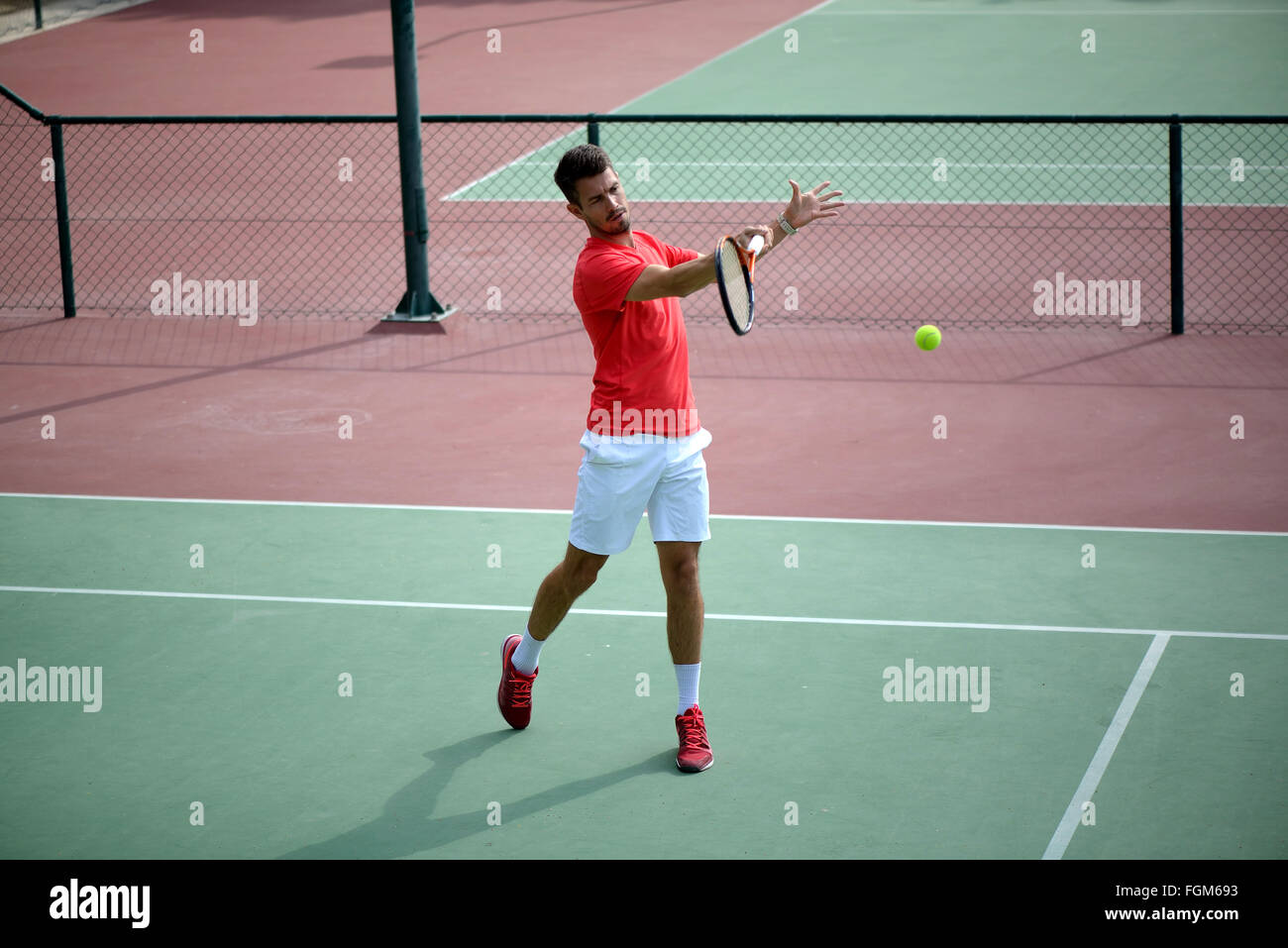 Male tennis player practice in tennis court in Dubai. Stock Photo