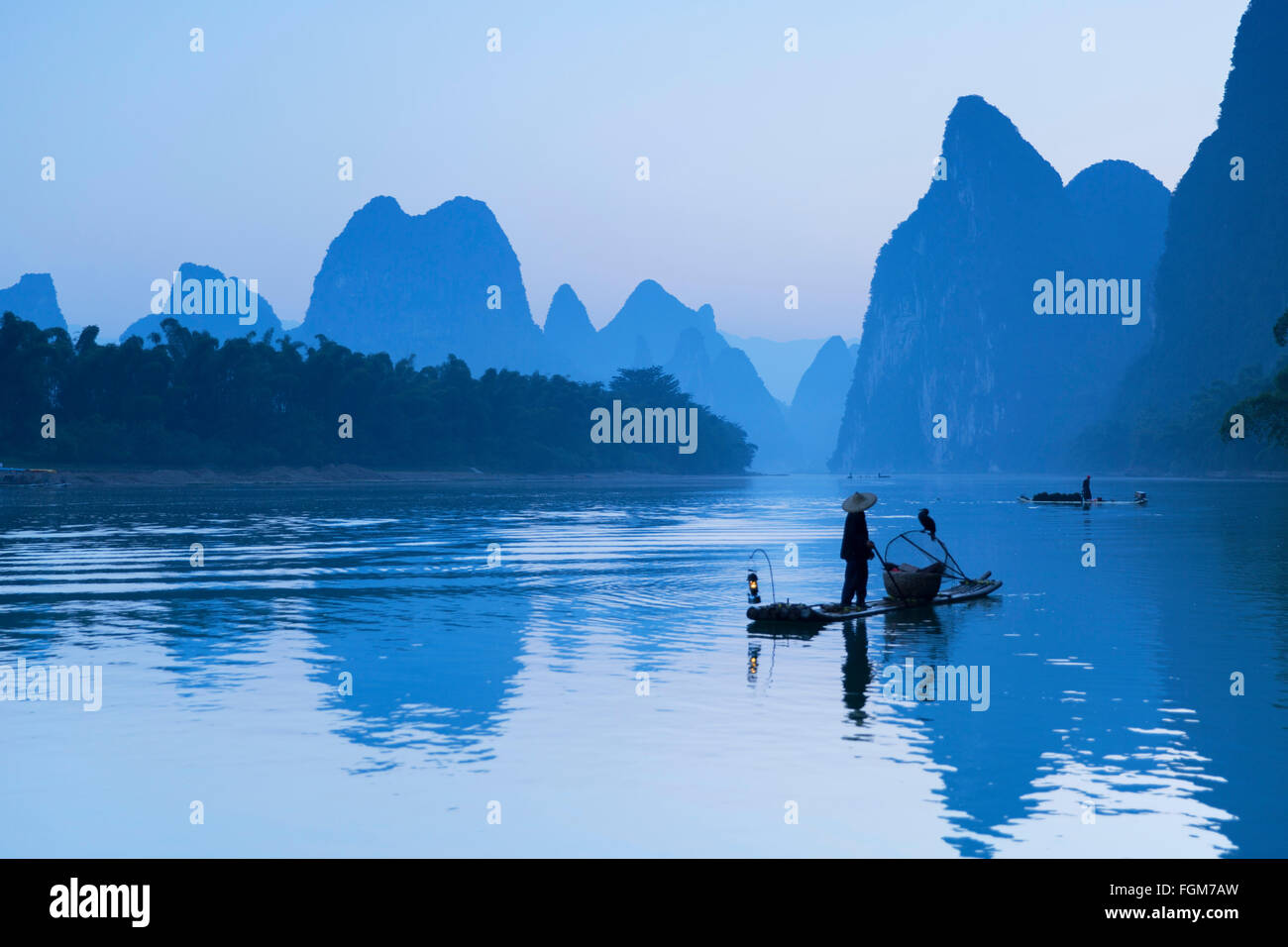 Cormorant fisherman on Li River at dawn, Xingping, Yangshuo, Guangxi, China Stock Photo