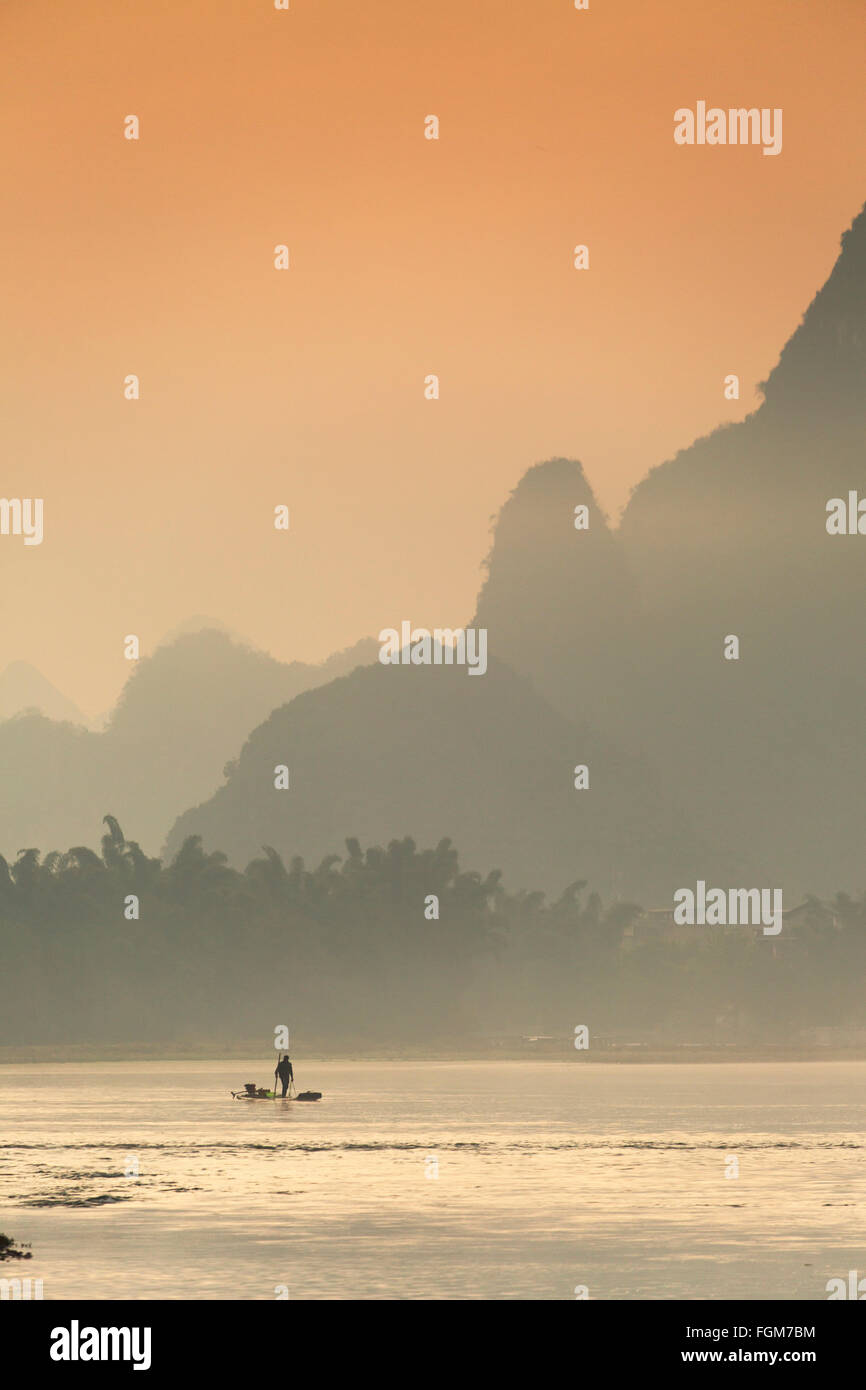 Fisherman on Li River at dawn, Xingping, Yangshuo, Guangxi, China Stock Photo