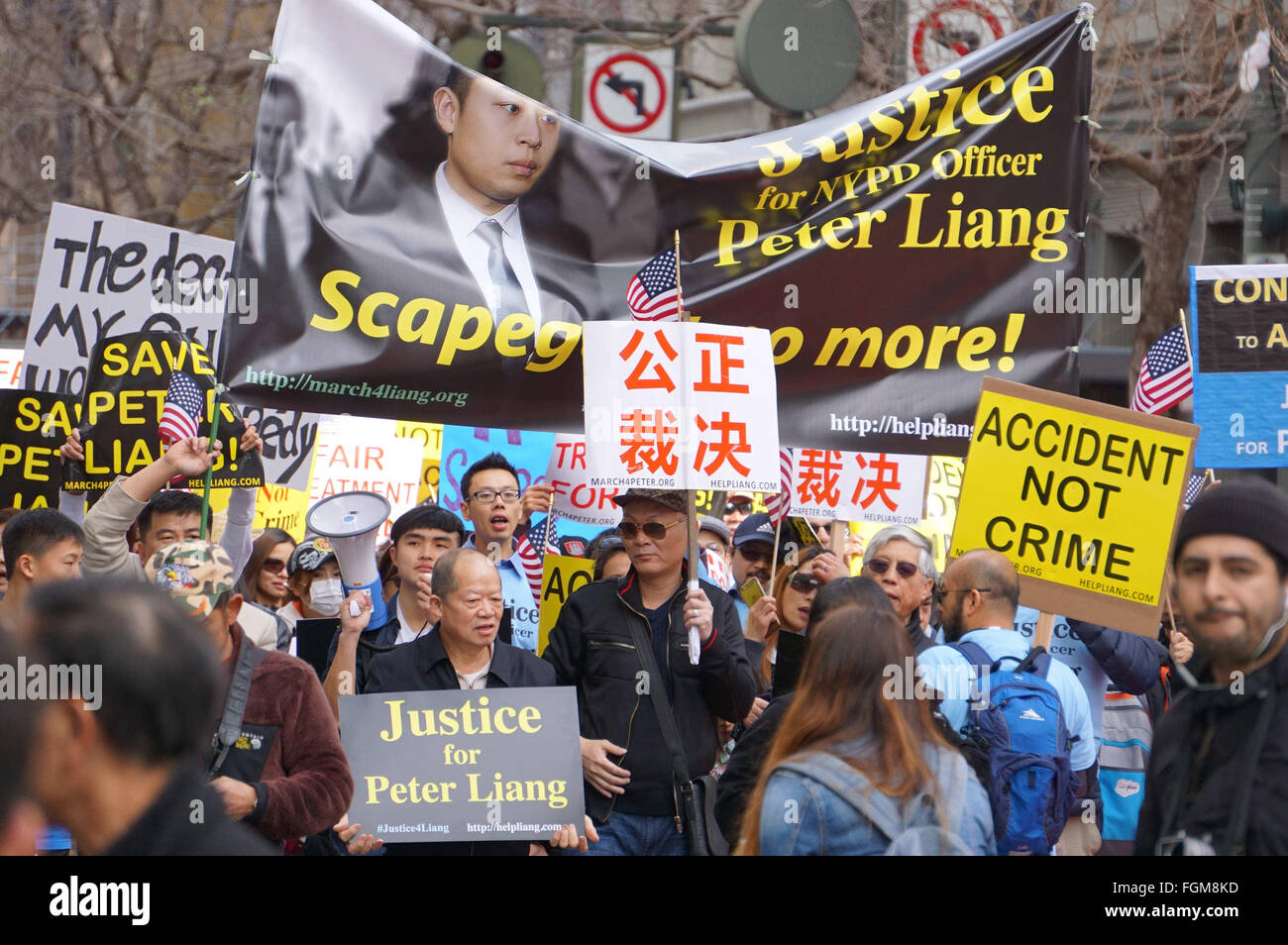 (160221) -- SAN FRANCISCO, Feb. 21, 2016 (Xinhua) -- People take part in a rally in support of New York City police officer Peter Liang, in San Francisco, the United States, Feb. 20, 2016. Tens of thousands of people rallied Saturday in more than 30 American cities to protest the conviction of Peter Liang, a former New York police officer of Chinese descent. A ricocheted bullet from Liang's service weapon accidentally killed African American Akai Gurley, an unarmed civilian, when the former New York police officer was patrolling in a housing project in the borough of Brooklyn in late November Stock Photo