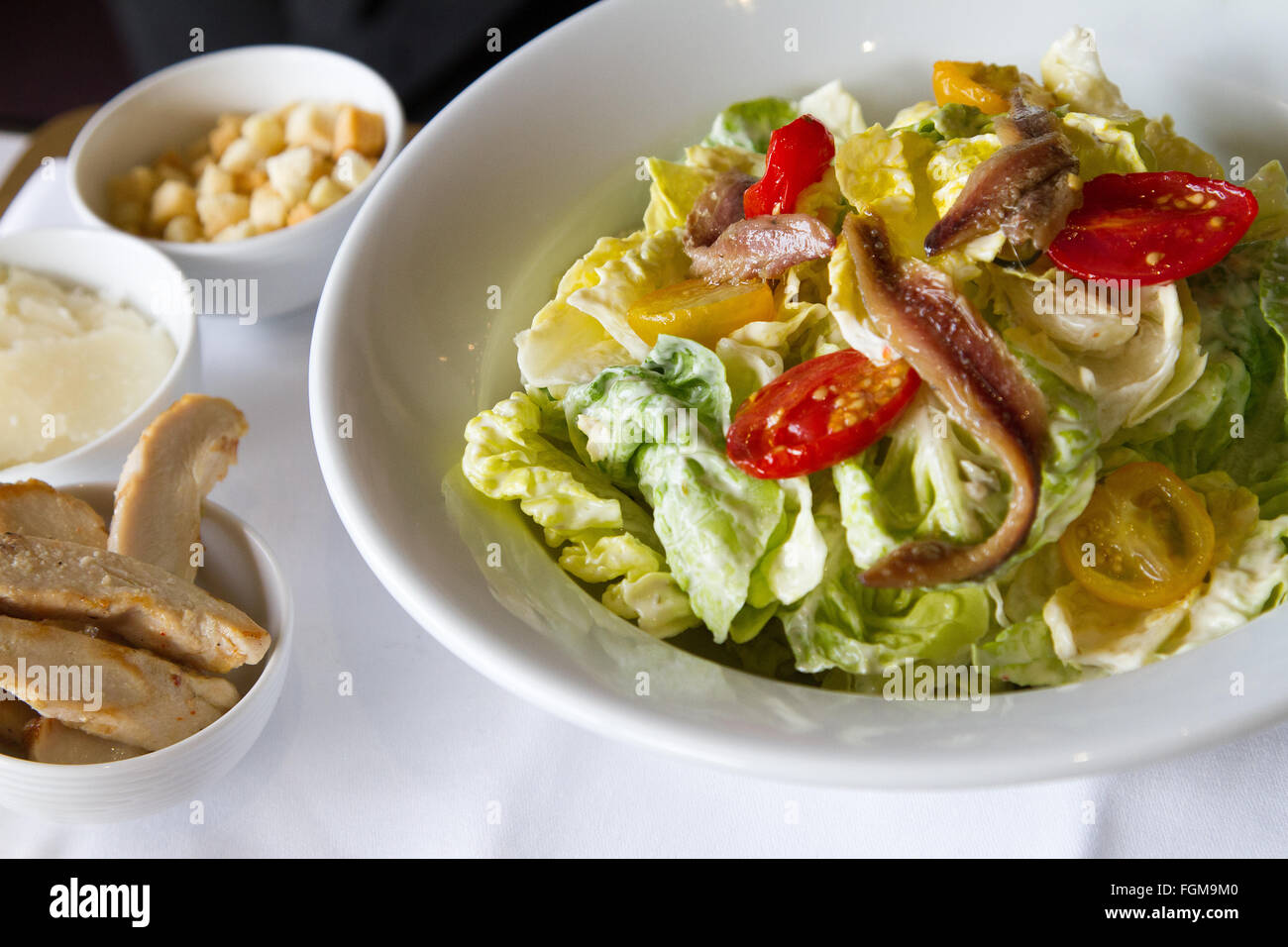 Healthy salad with greens tomatoes and fish Stock Photo