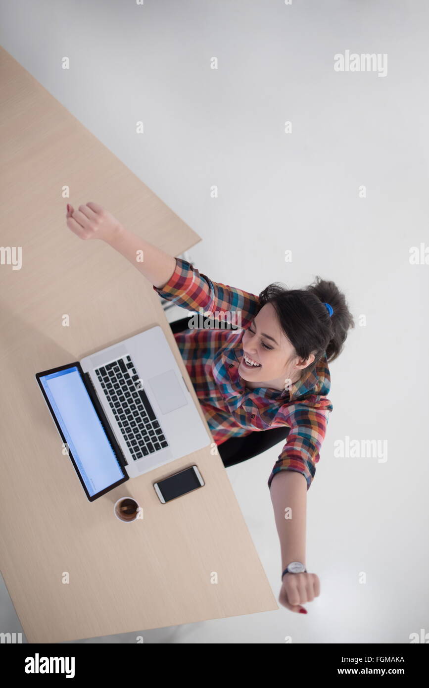 top view of young business woman working on laptop computer in modern ...