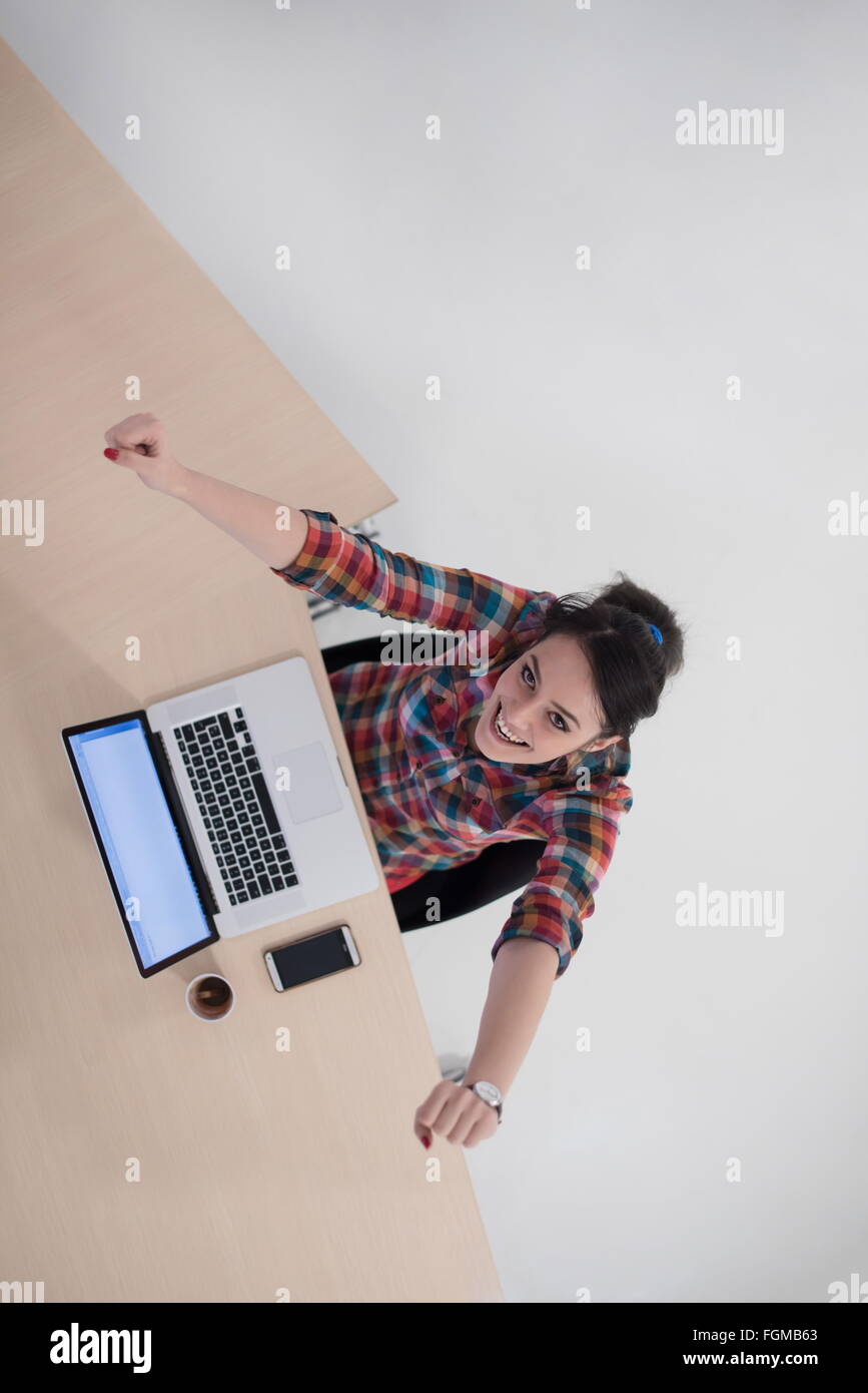 top view of young business woman working on laptop computer in modern ...