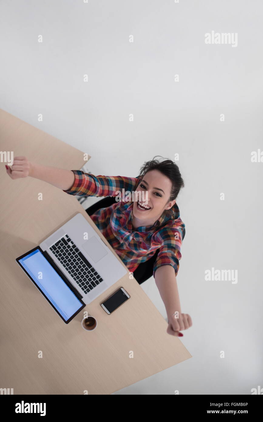 top view of young business woman working on laptop computer in modern ...