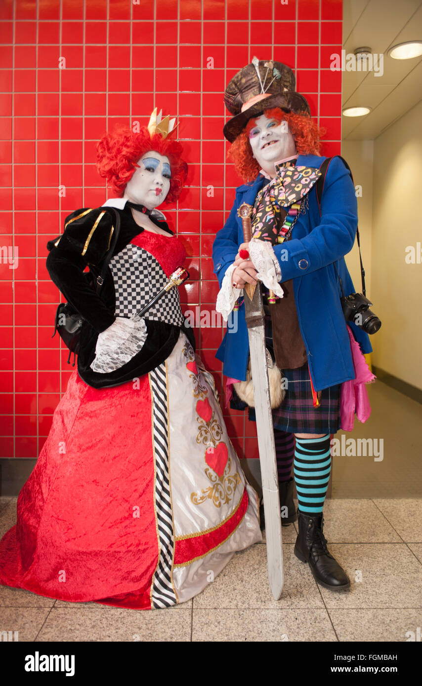 The 2016 London Super Comic Convention, Queen of Hearts and Mad Hatter cosplay visitors from 2010 Alice in Wonderland film. Stock Photo