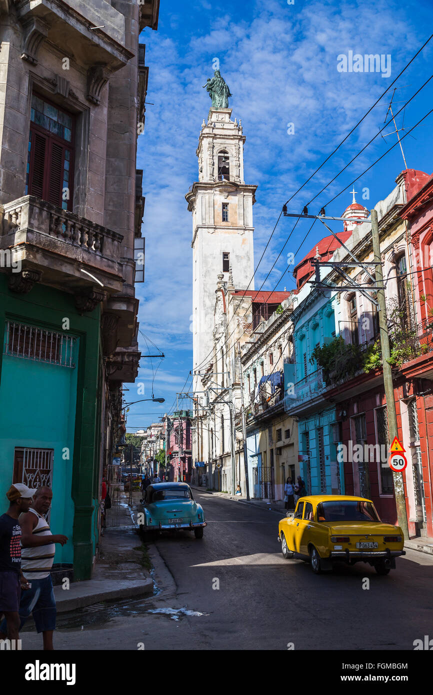 A statue high up in the sky, positioned on an old tower near the hospital in Centro Havana. Stock Photo