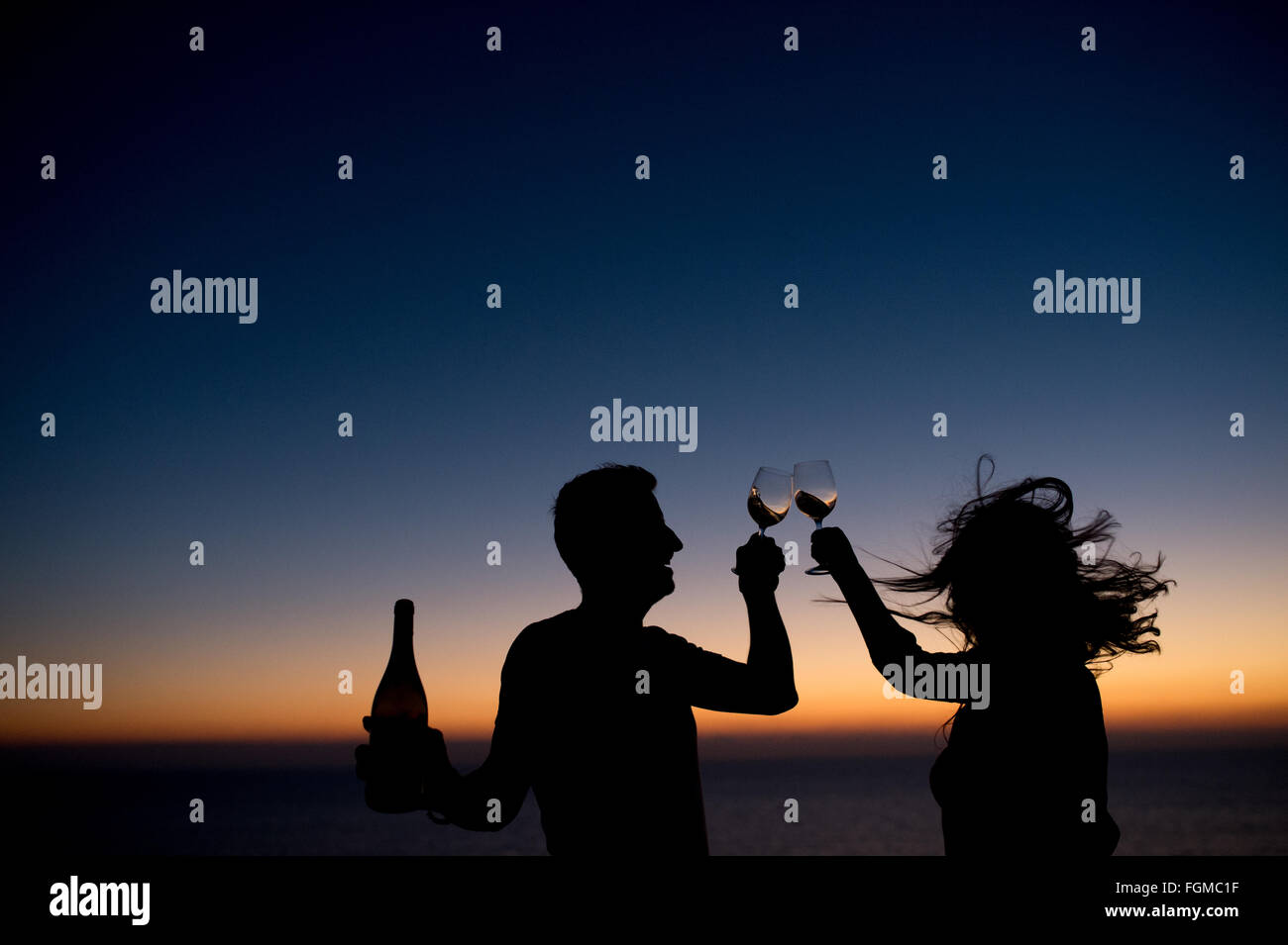 Silhouette couple drinking wine sunset hi-res stock photography and ...